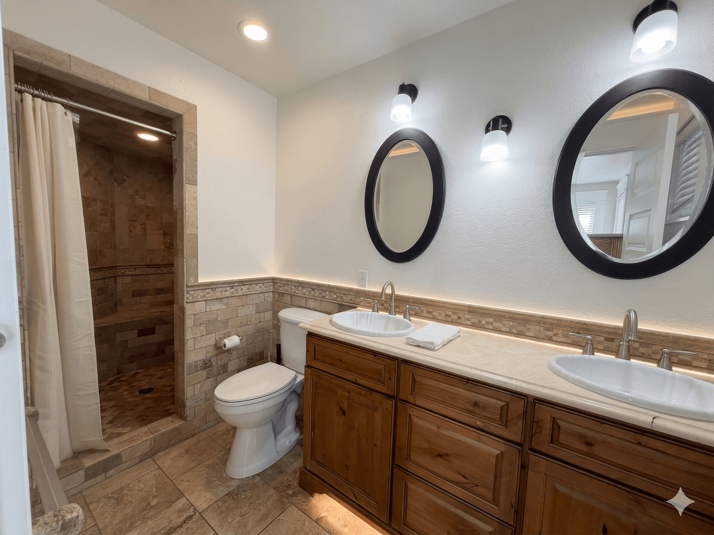 Bathroom 3 — Full View with Dual Vanity, Round Mirrors & Travertine Tiled Walk-In Shower | Ensuite at The Mark Twain, Outer Banks
