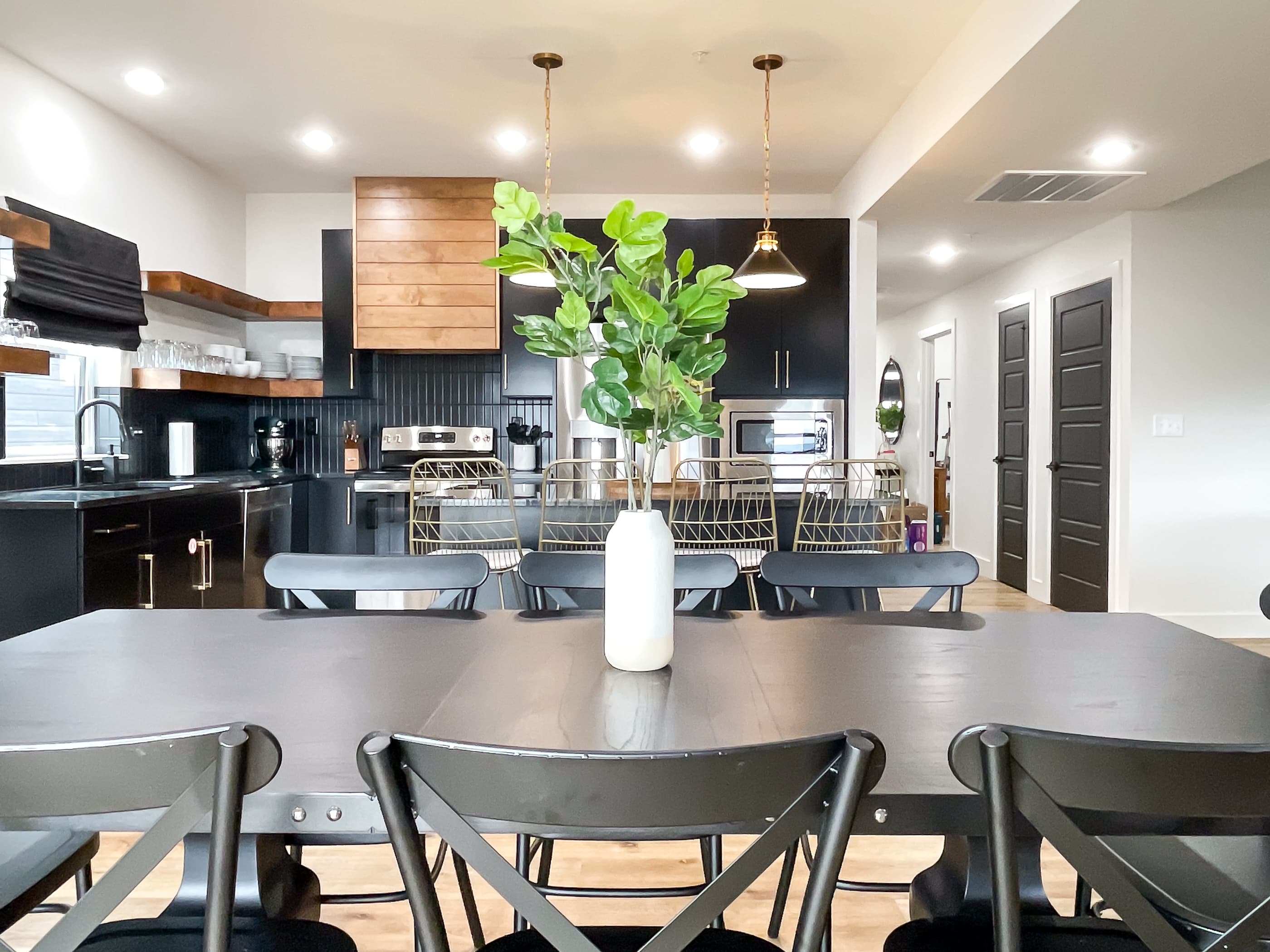 The sun shines beautifully through the windows to light up the dining room/kitchen