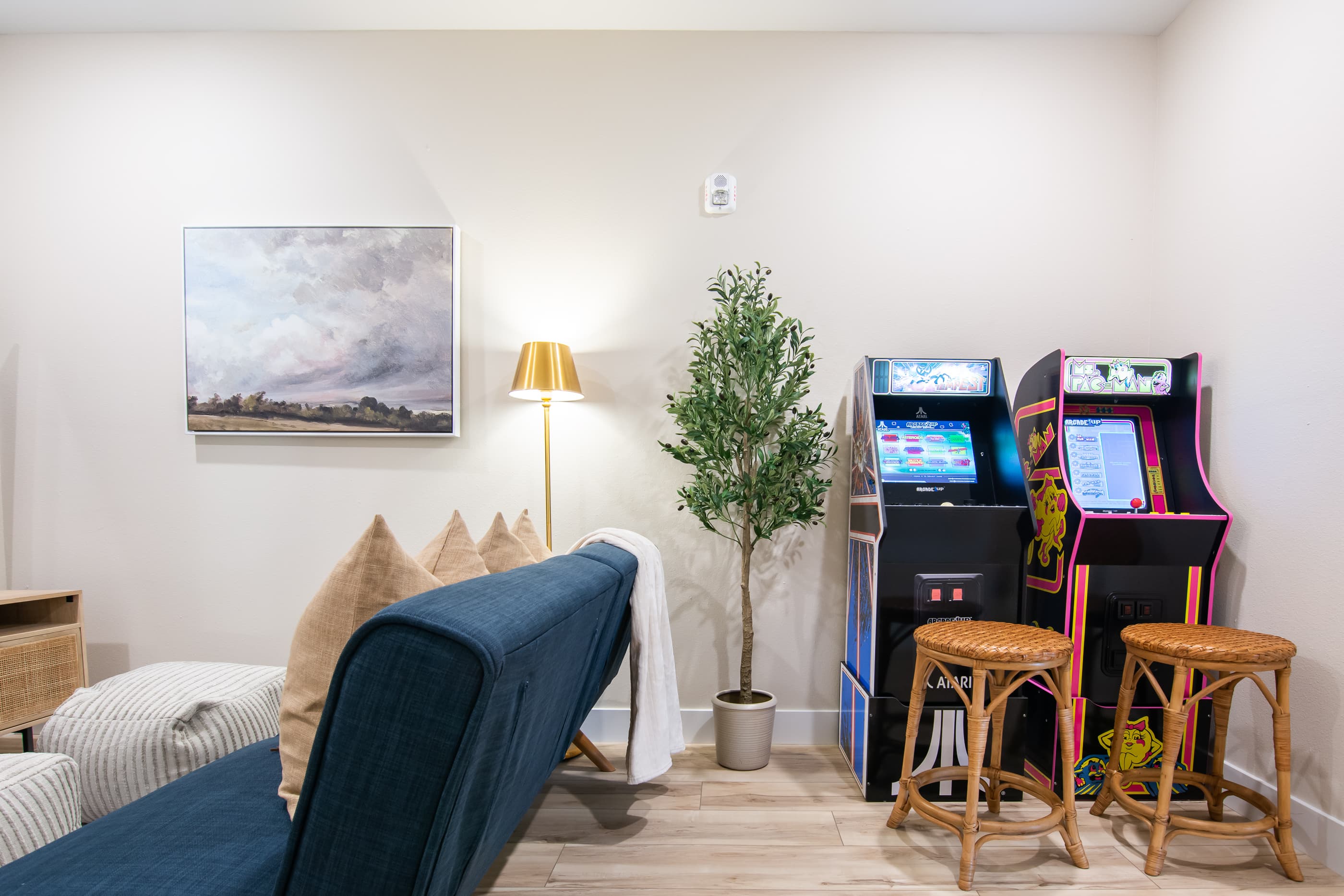 Upper level game/TV room with arcade games and sofa for watching movies
