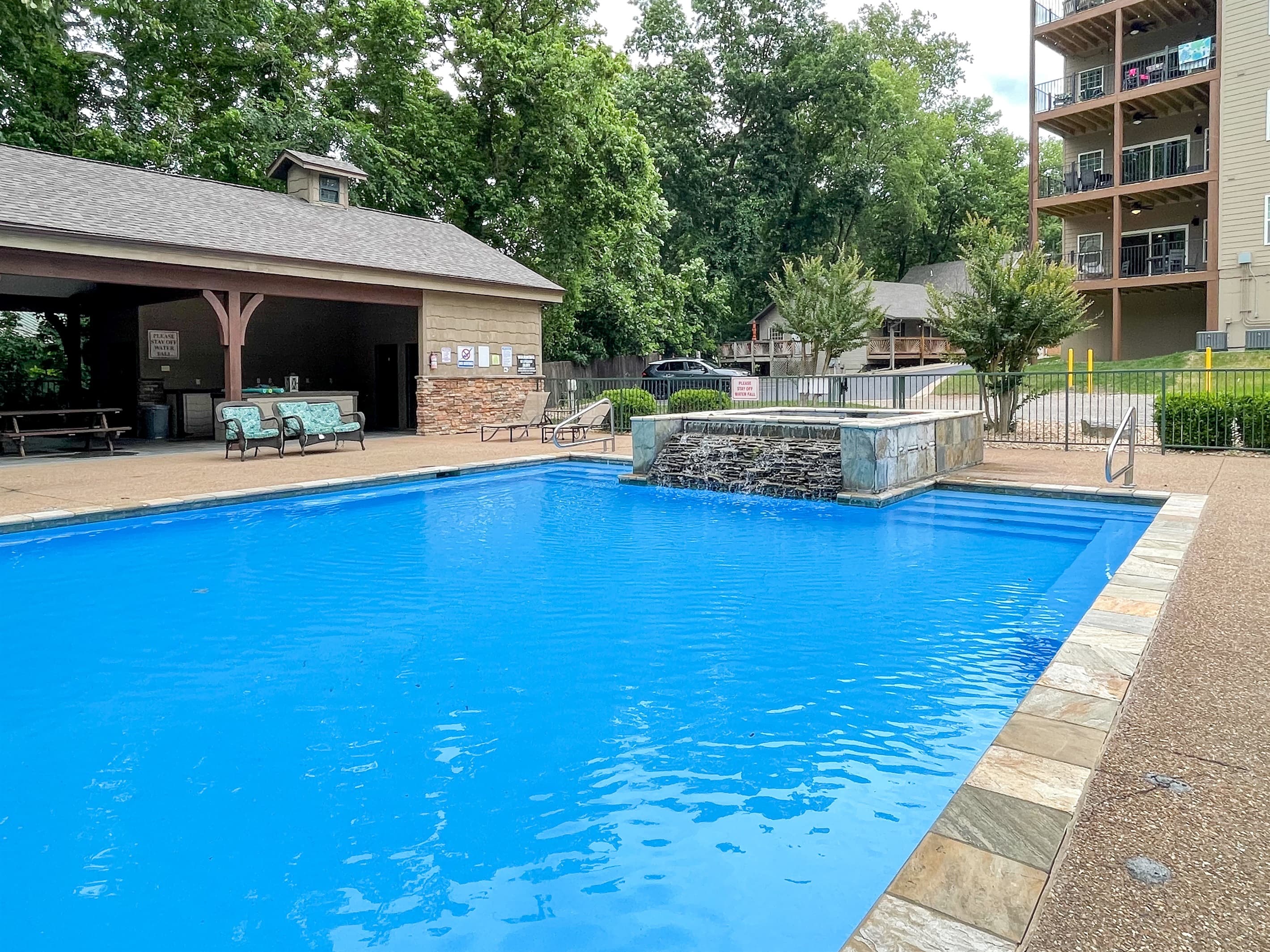 Neighborhood pool with beautiful waterfall feature
