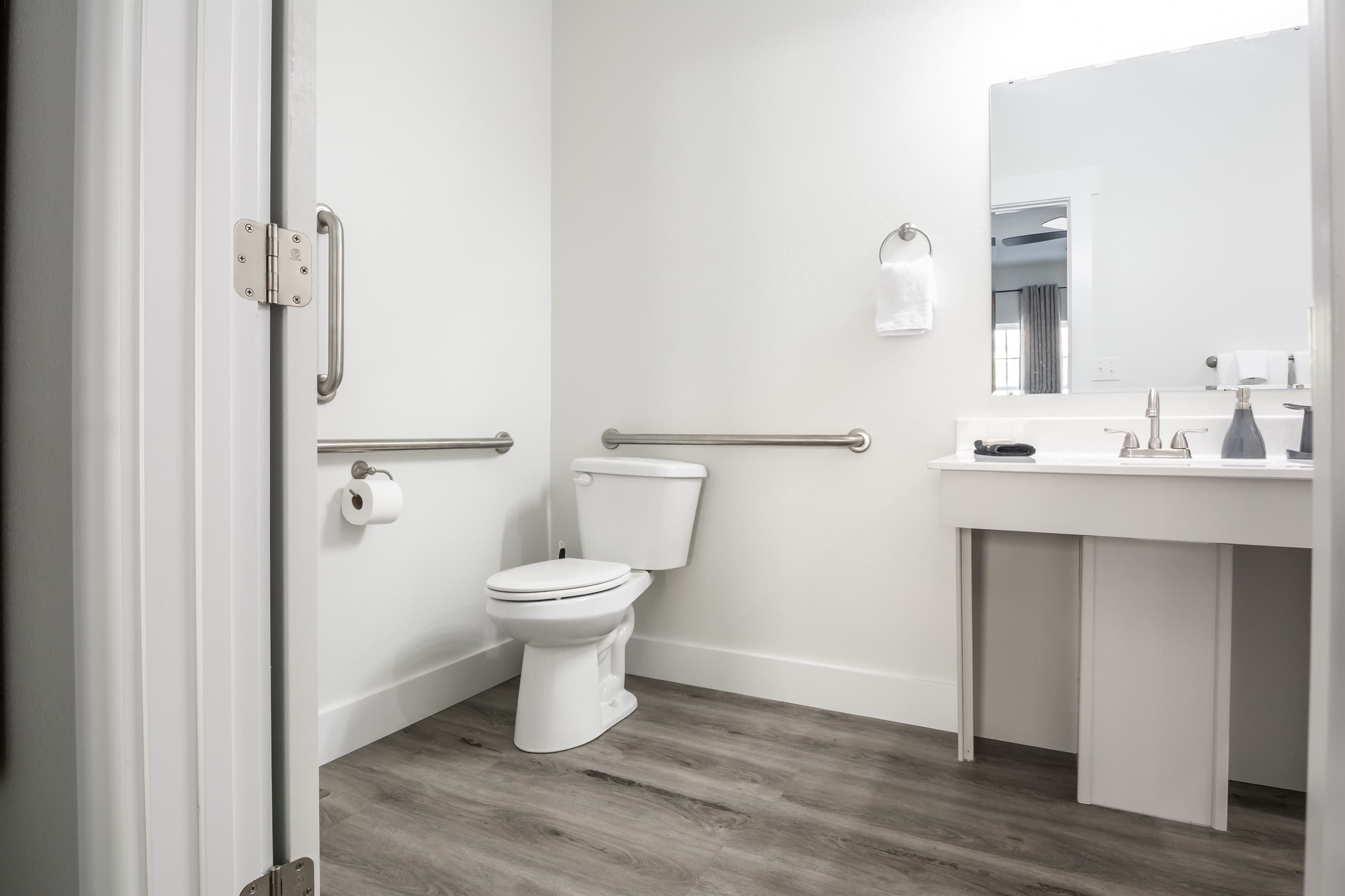 Bedroom 2 (main level, accessible): Toilet has grab bars available and a huge vanity