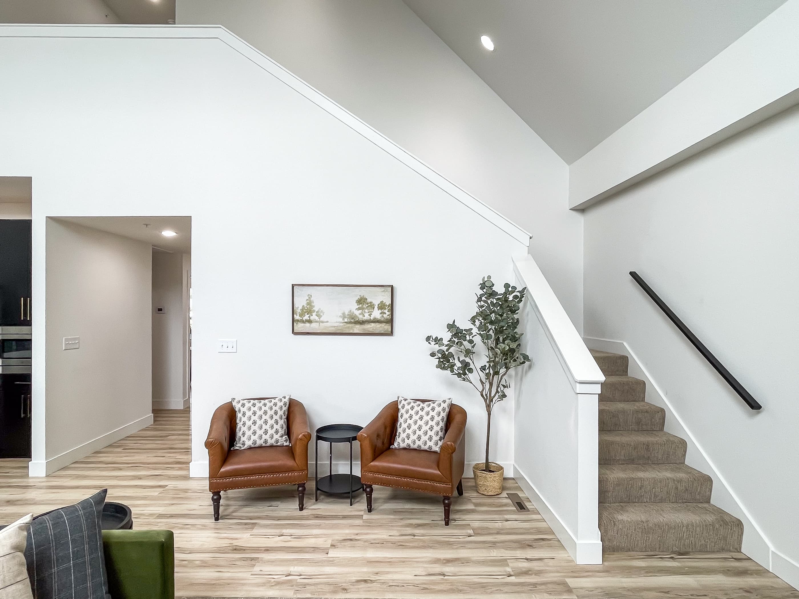Main level great room and stair access to upper level with hand rails