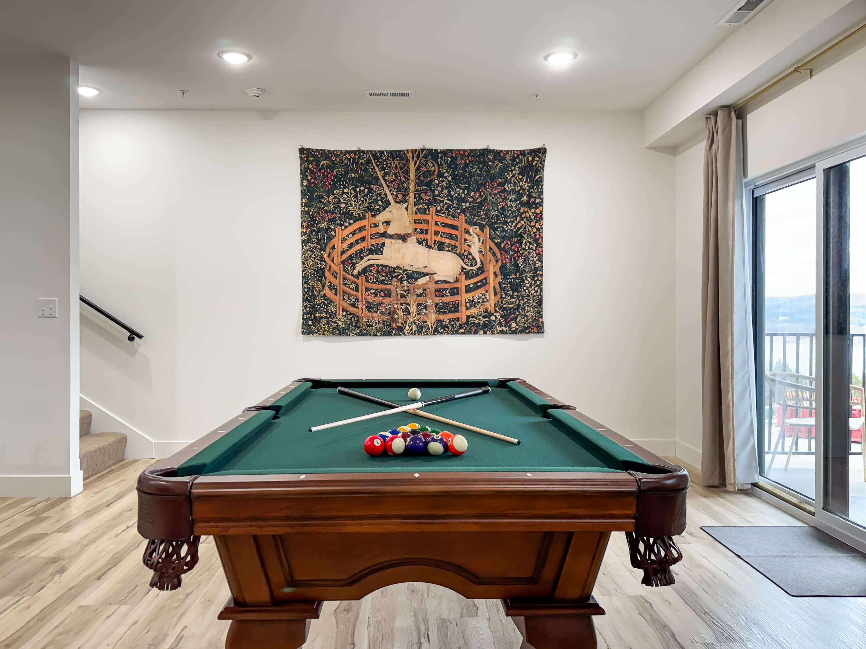 Lower level game room with pool table and access to lower level patio