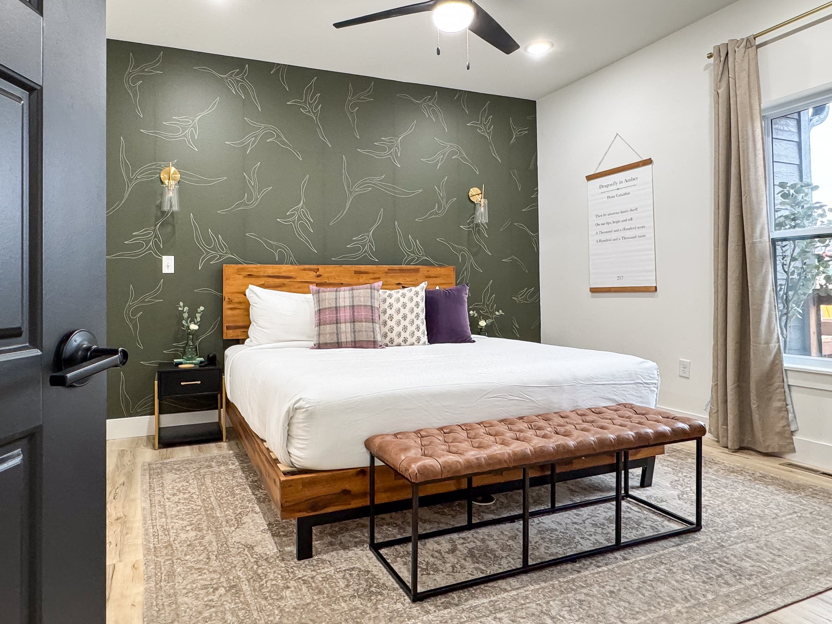 Main level king bedroom with inviting style and ample space around bed