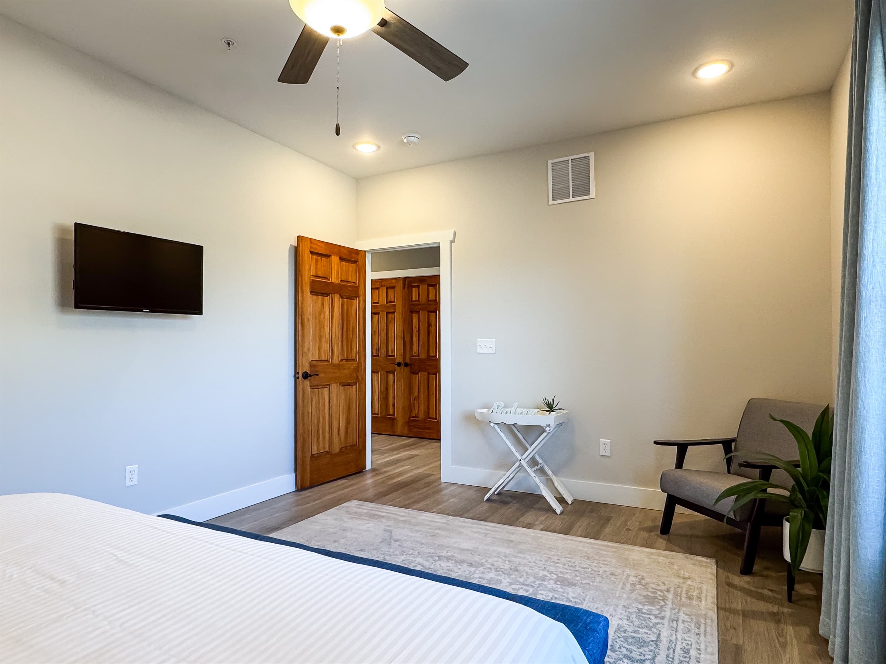 Main level king bedroom with substantial room and sitting chair