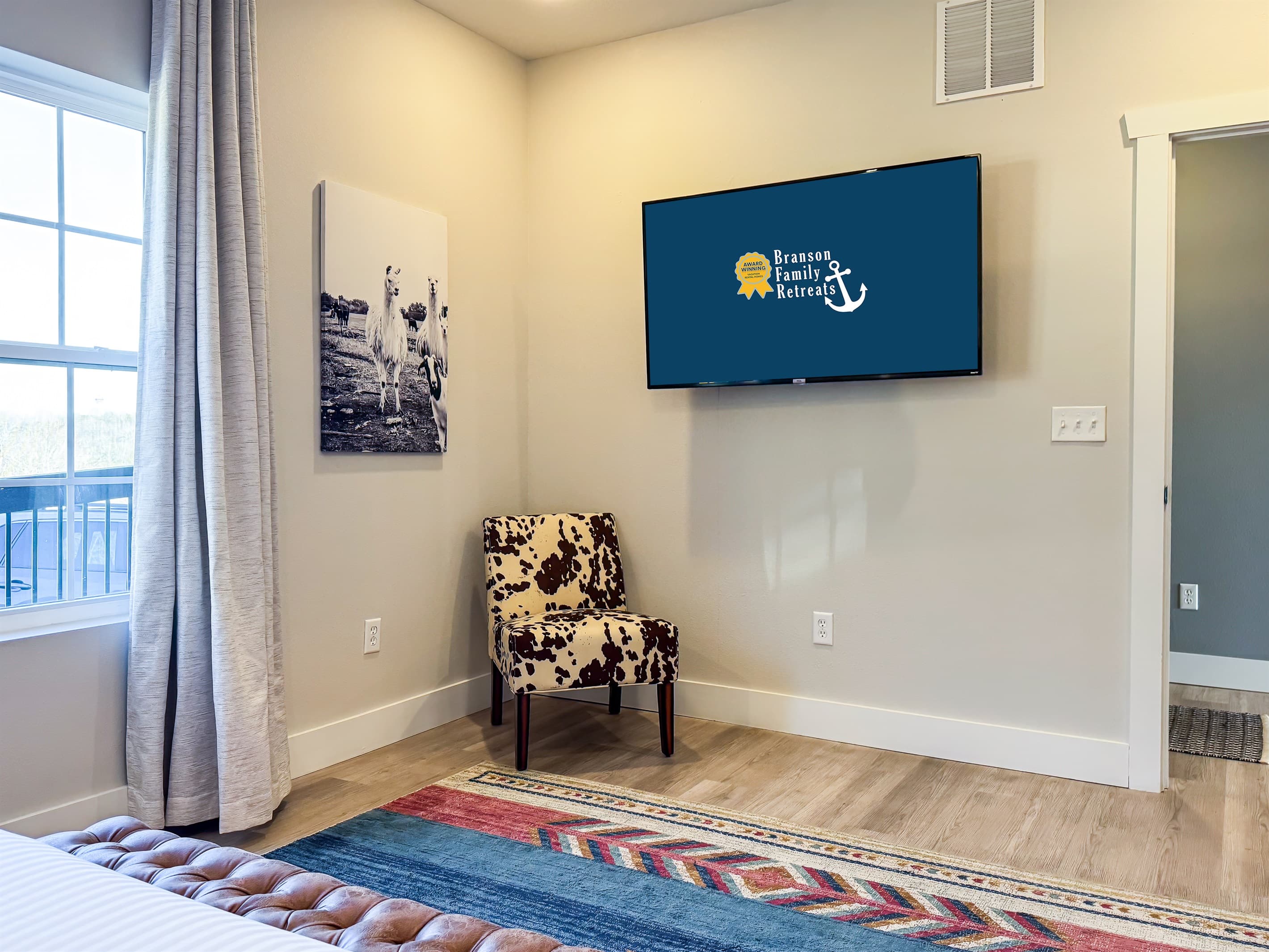 Main level king bedroom with seating chair