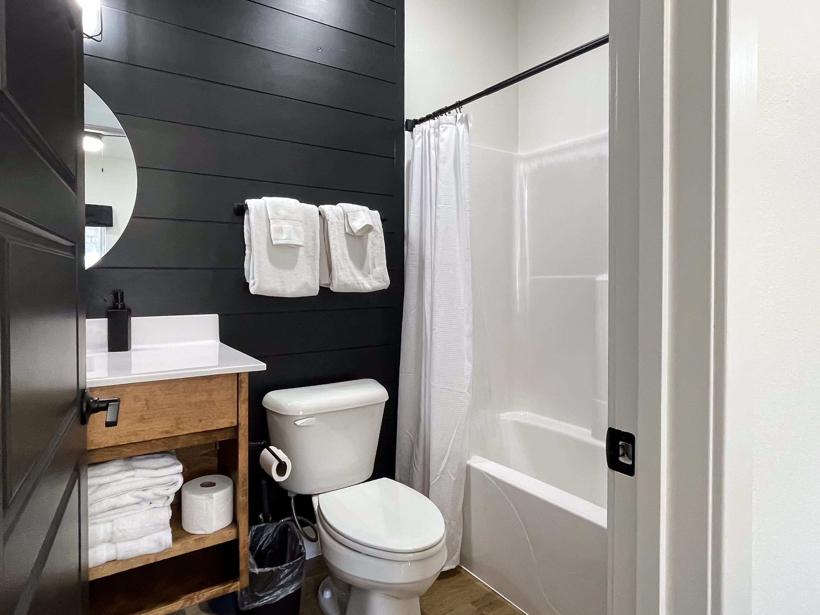 Bedroom 2: Connected bathroom with tub shower, toilet, and vanity
