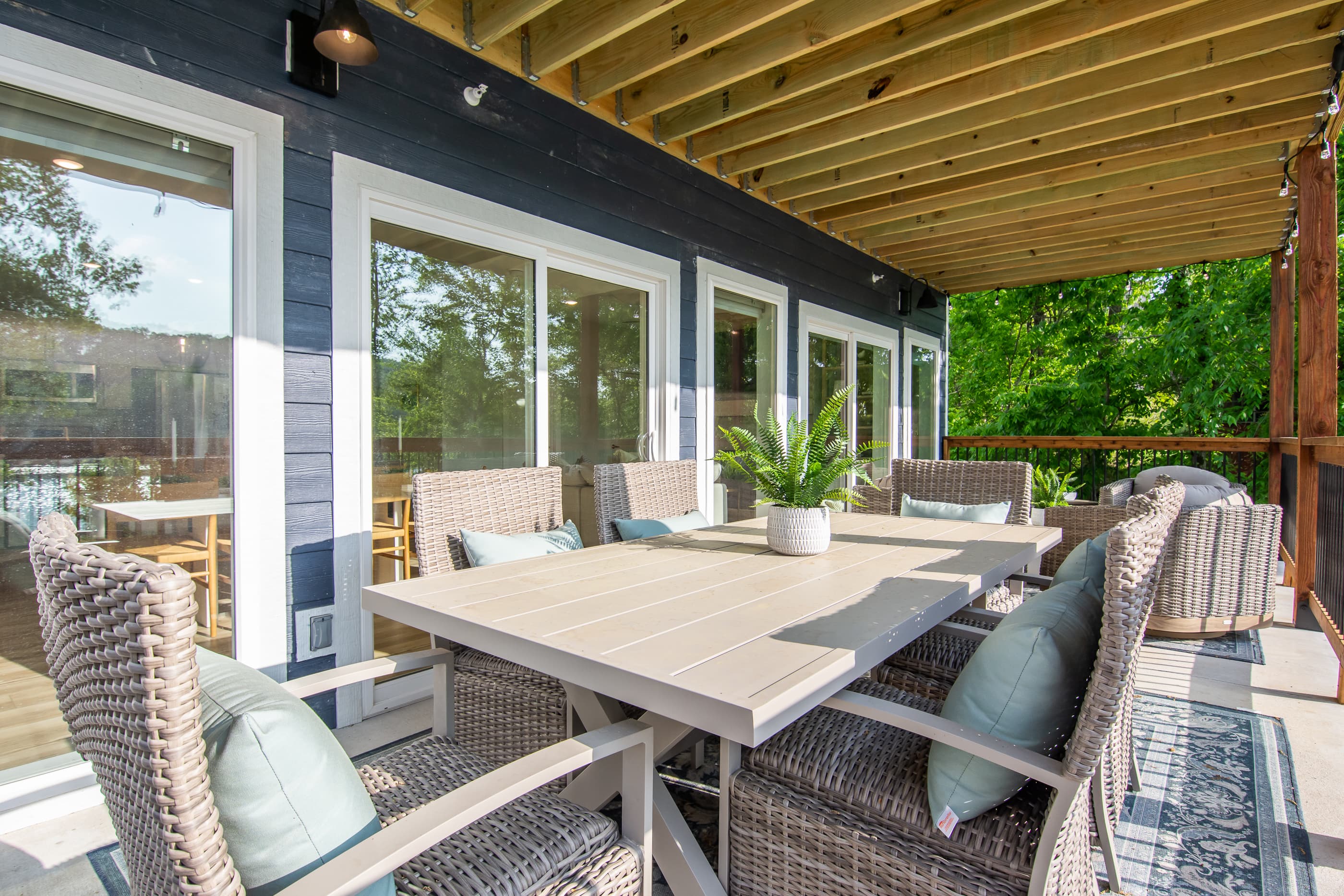 Main level patio with abundant seating, grill, hot tub and lake views