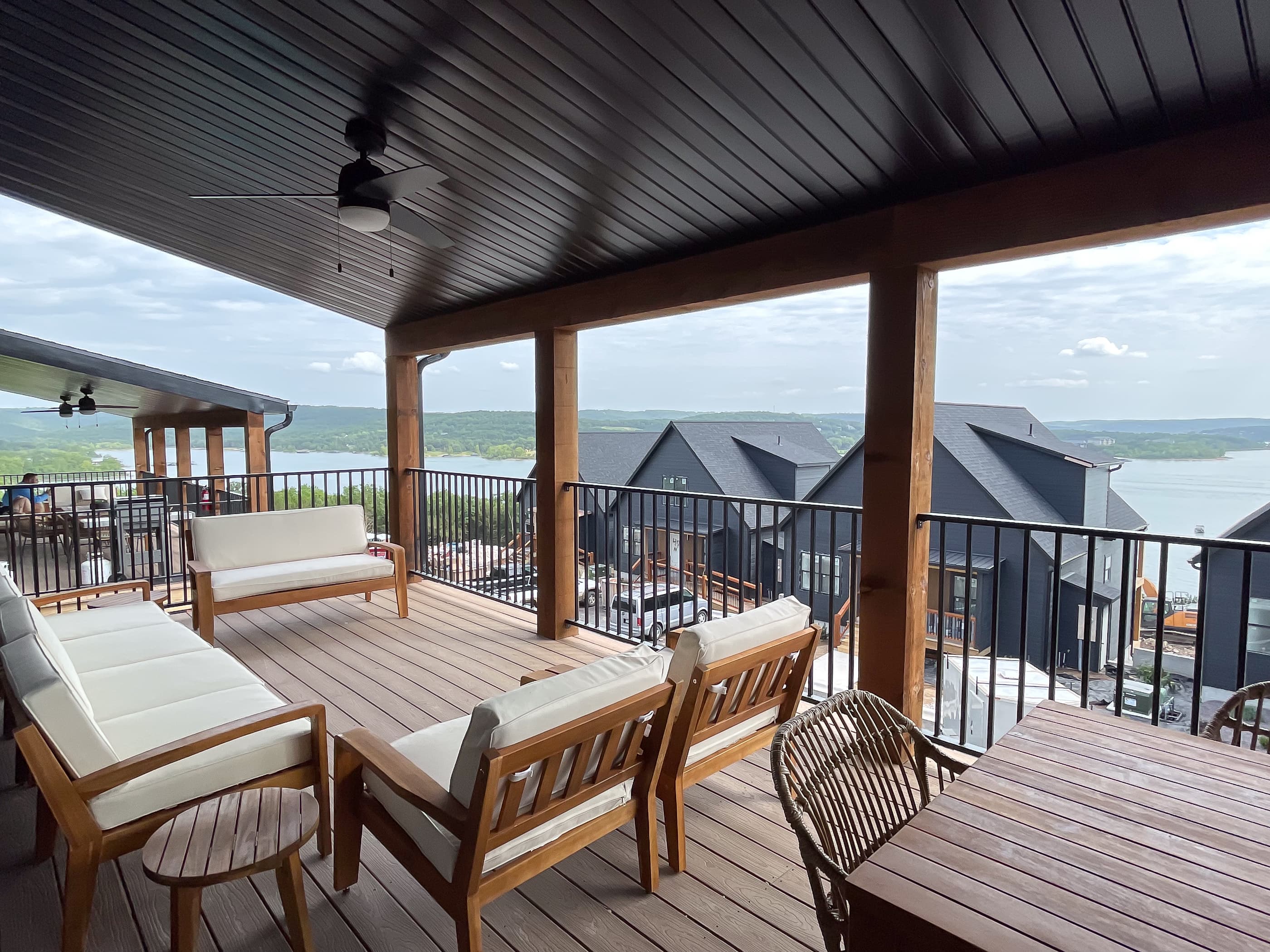 Deck with main level access, cozy seating, and stunning lake views