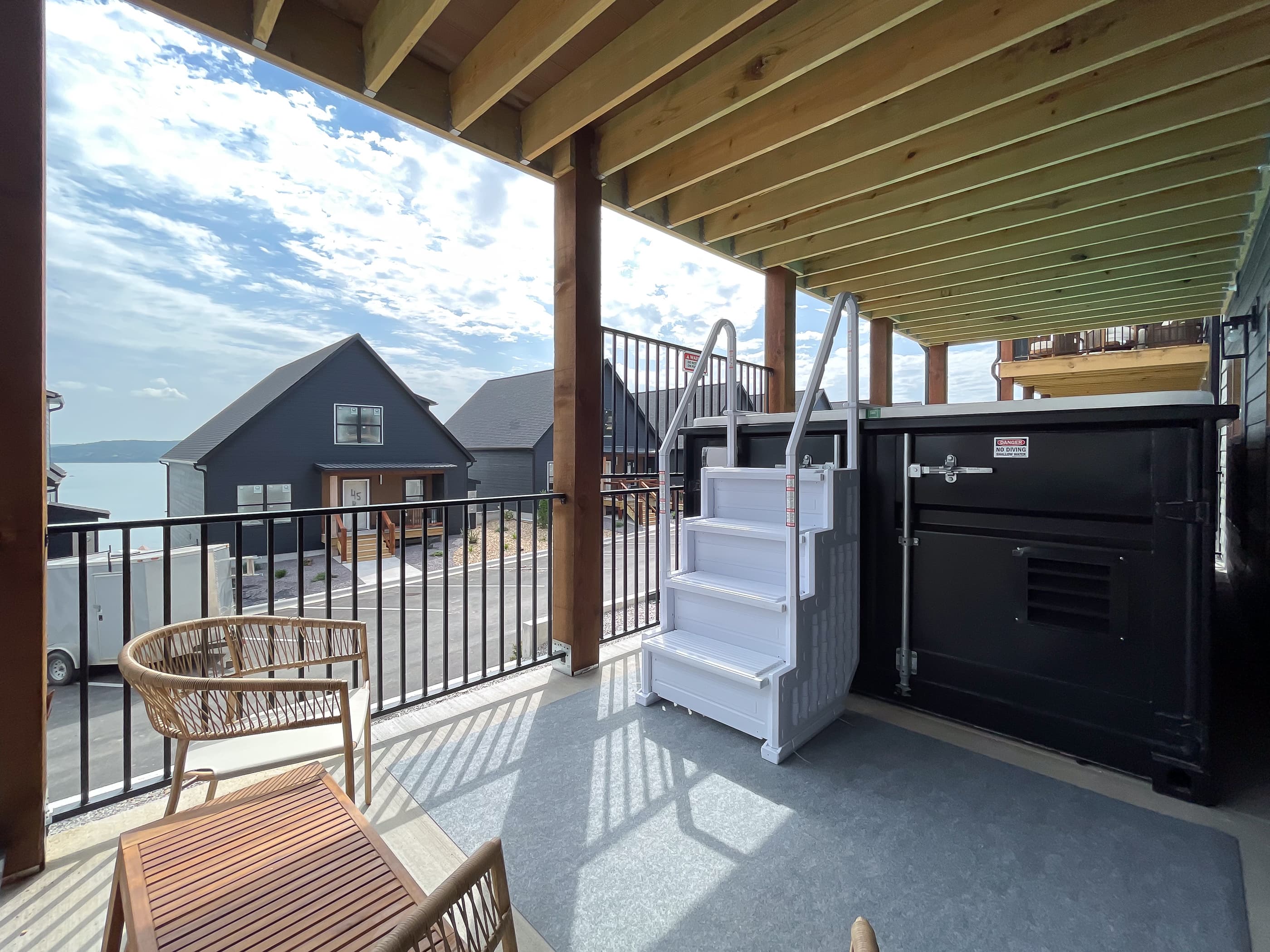 Lower level deck with table and chairs, and container pool
