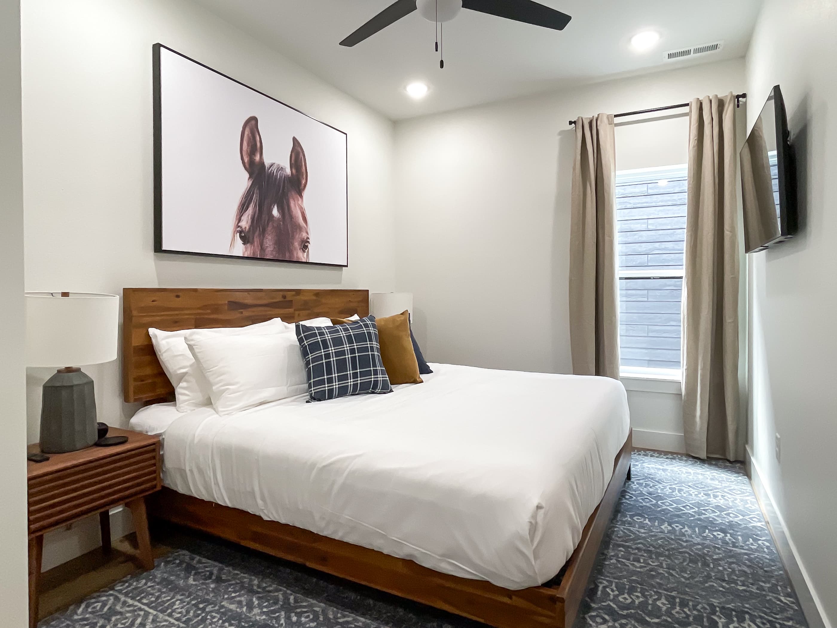 Lower level middle bedroom with nightstands, tv, and en suite bathroom