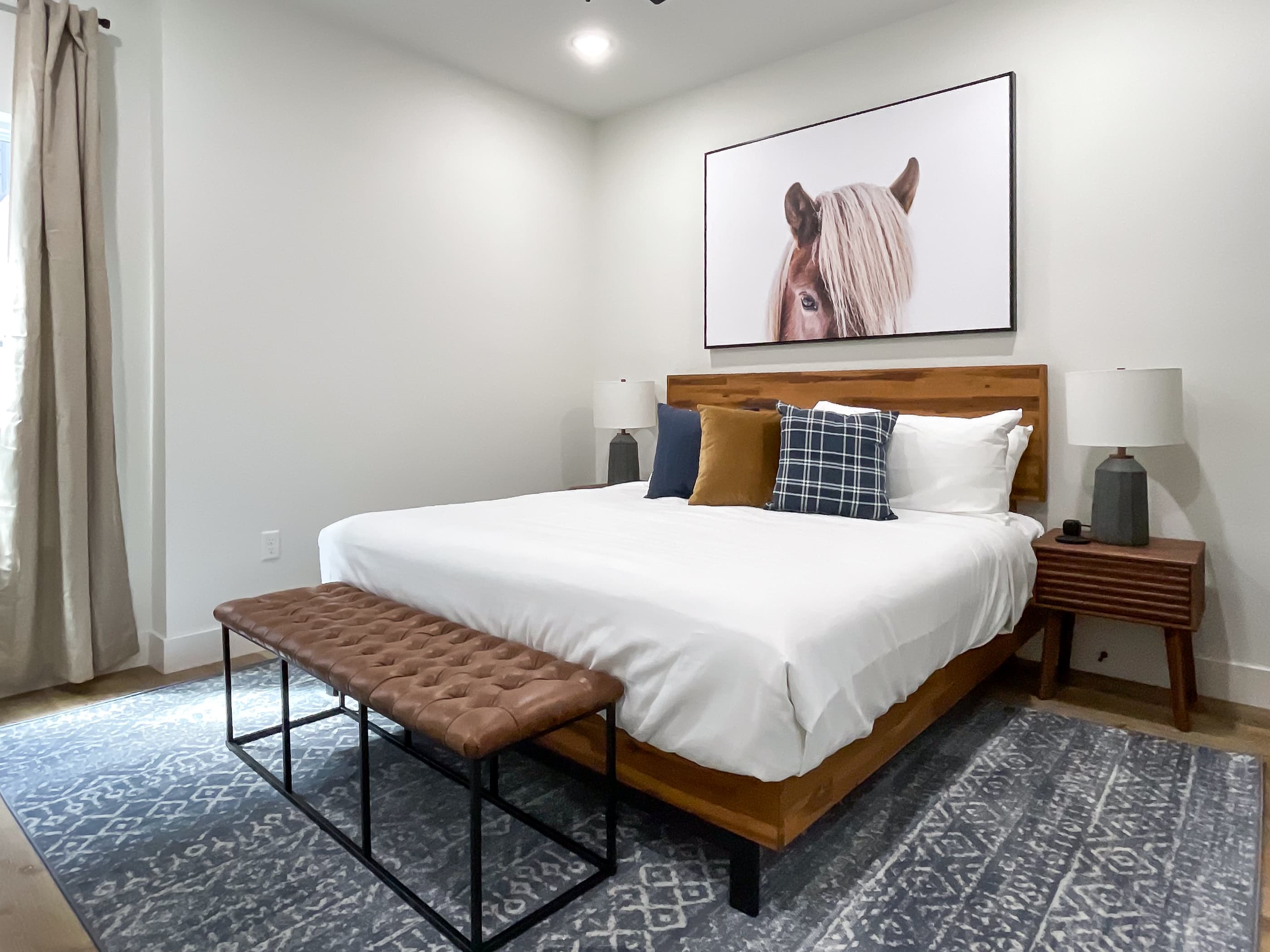 Inviting lower level bedroom with cozy king bed, bench seating and nightstands