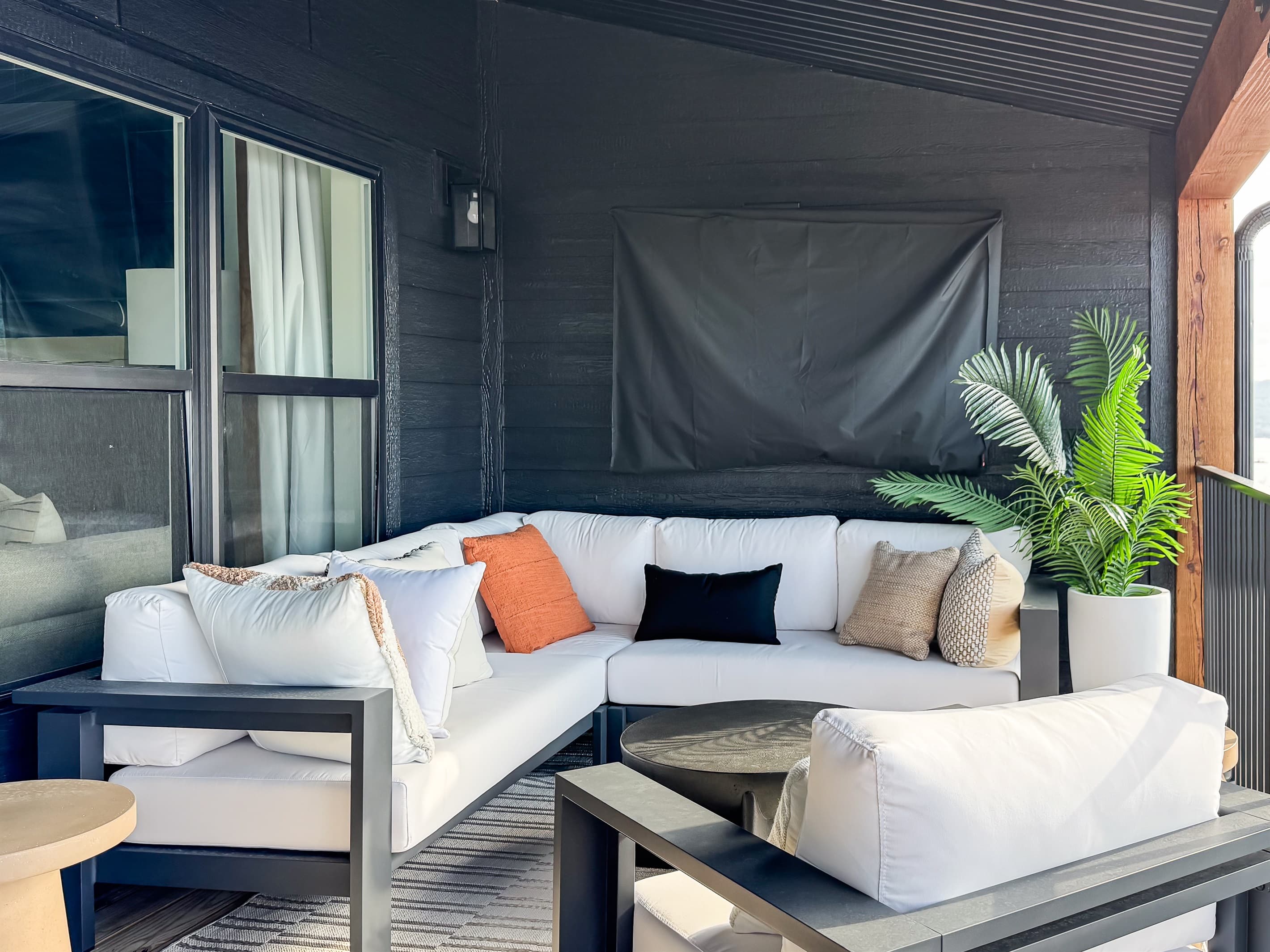 Sectional seating on deck with Tv behind it
