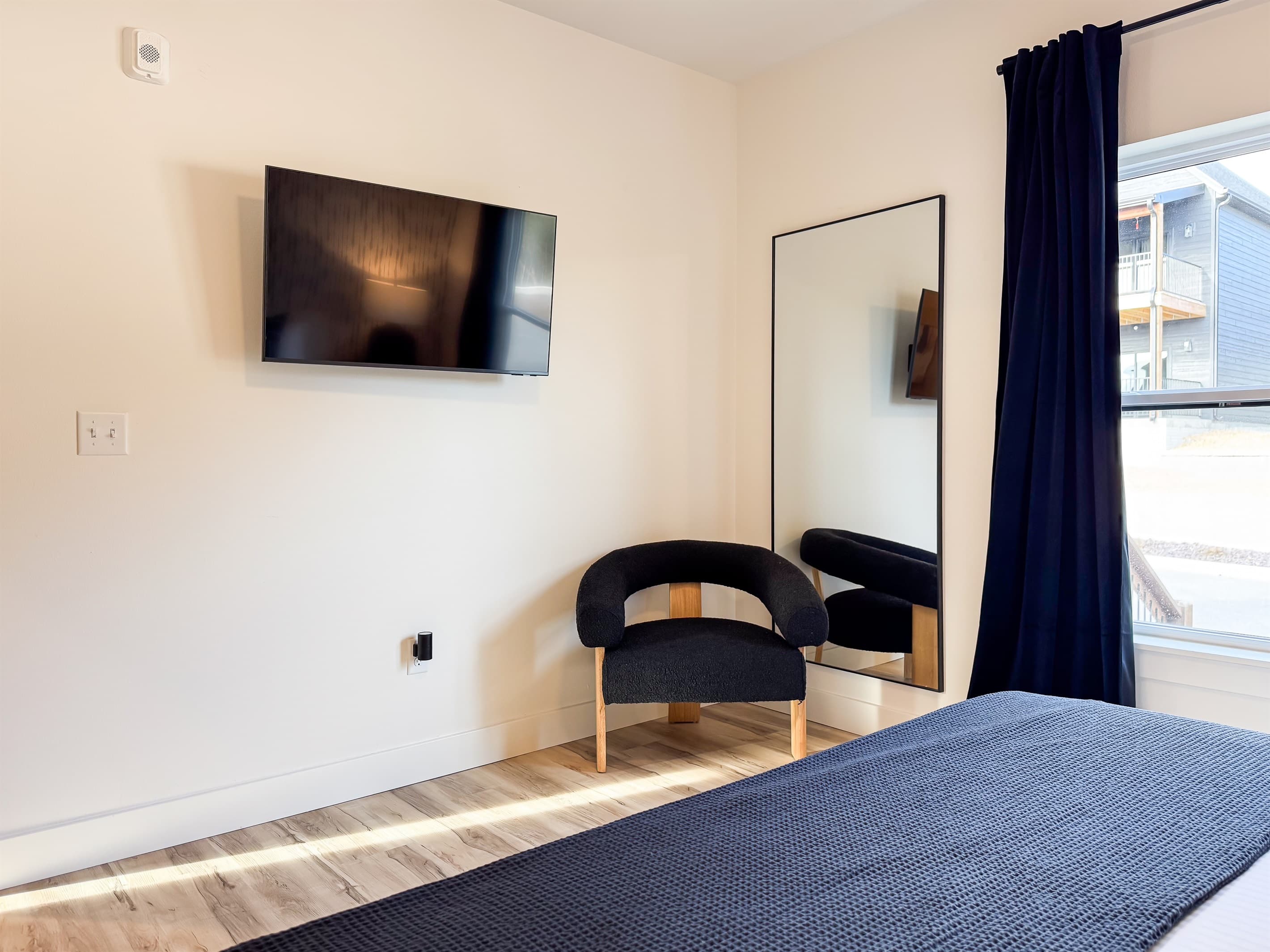 Bedroom 1: Tv across the bed with chair and full length mirror