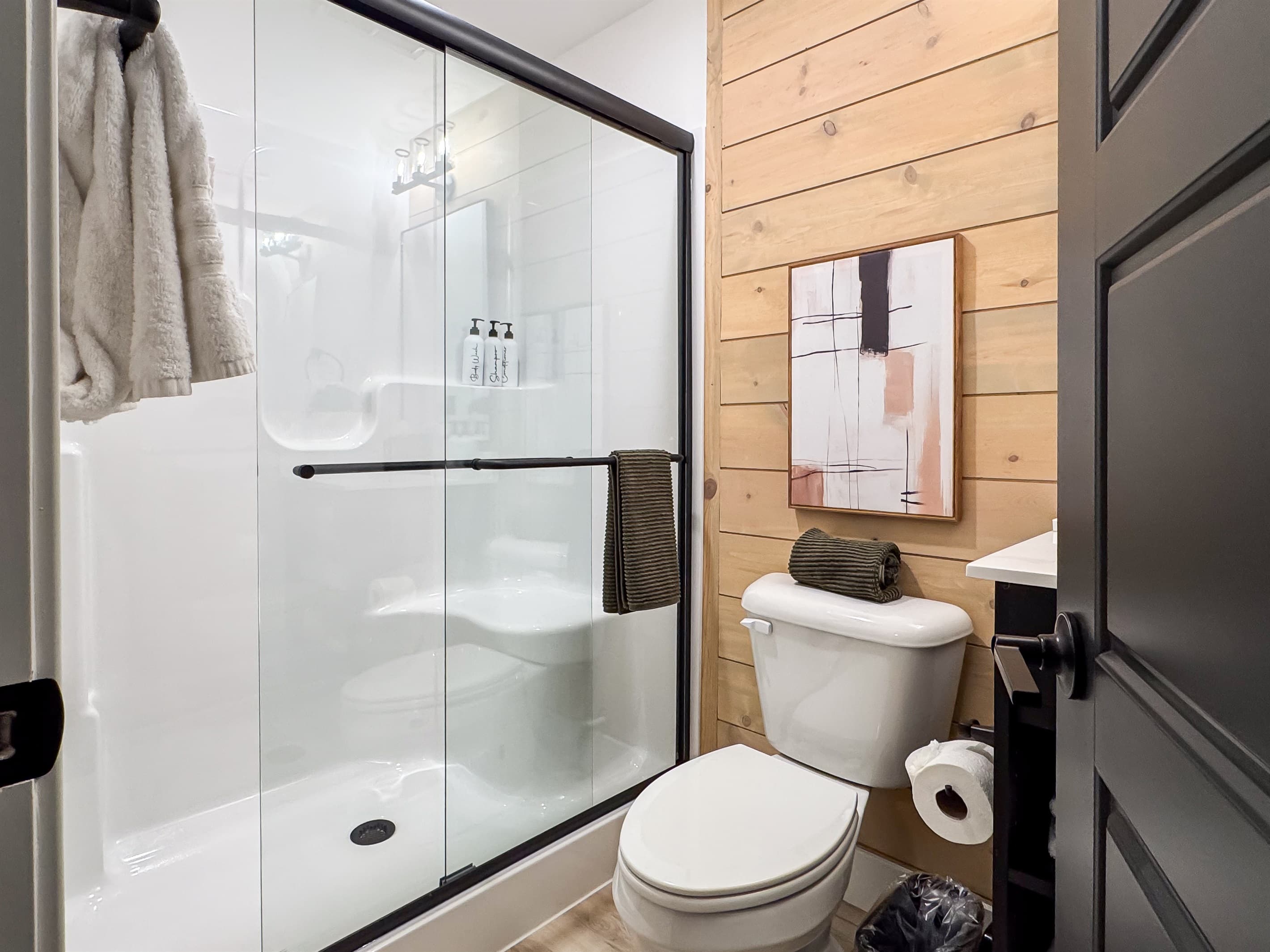 Bedroom 6: En-suite bathroom with low curb shower, toilet, and vanity
