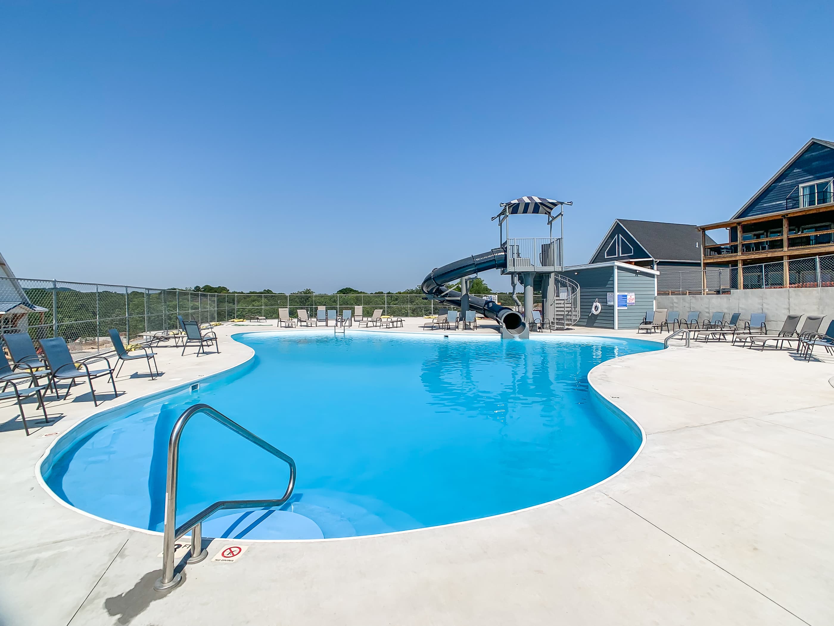 Outdoor pool with handle bar and steps to get in