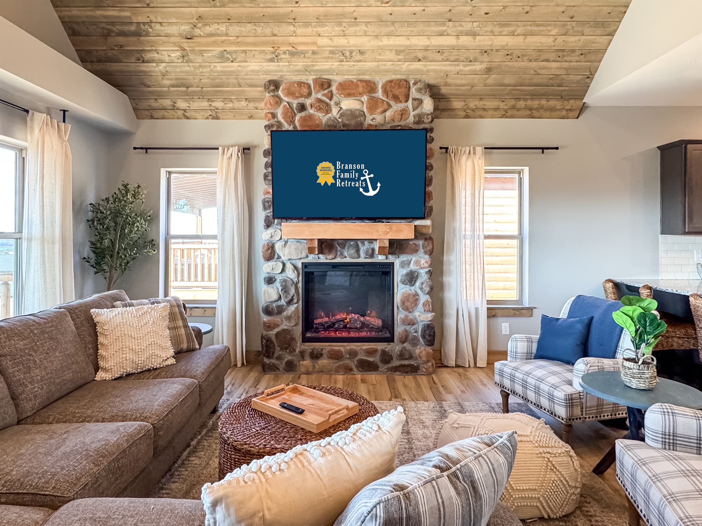 Upper level living room with big screen and electric fireplace