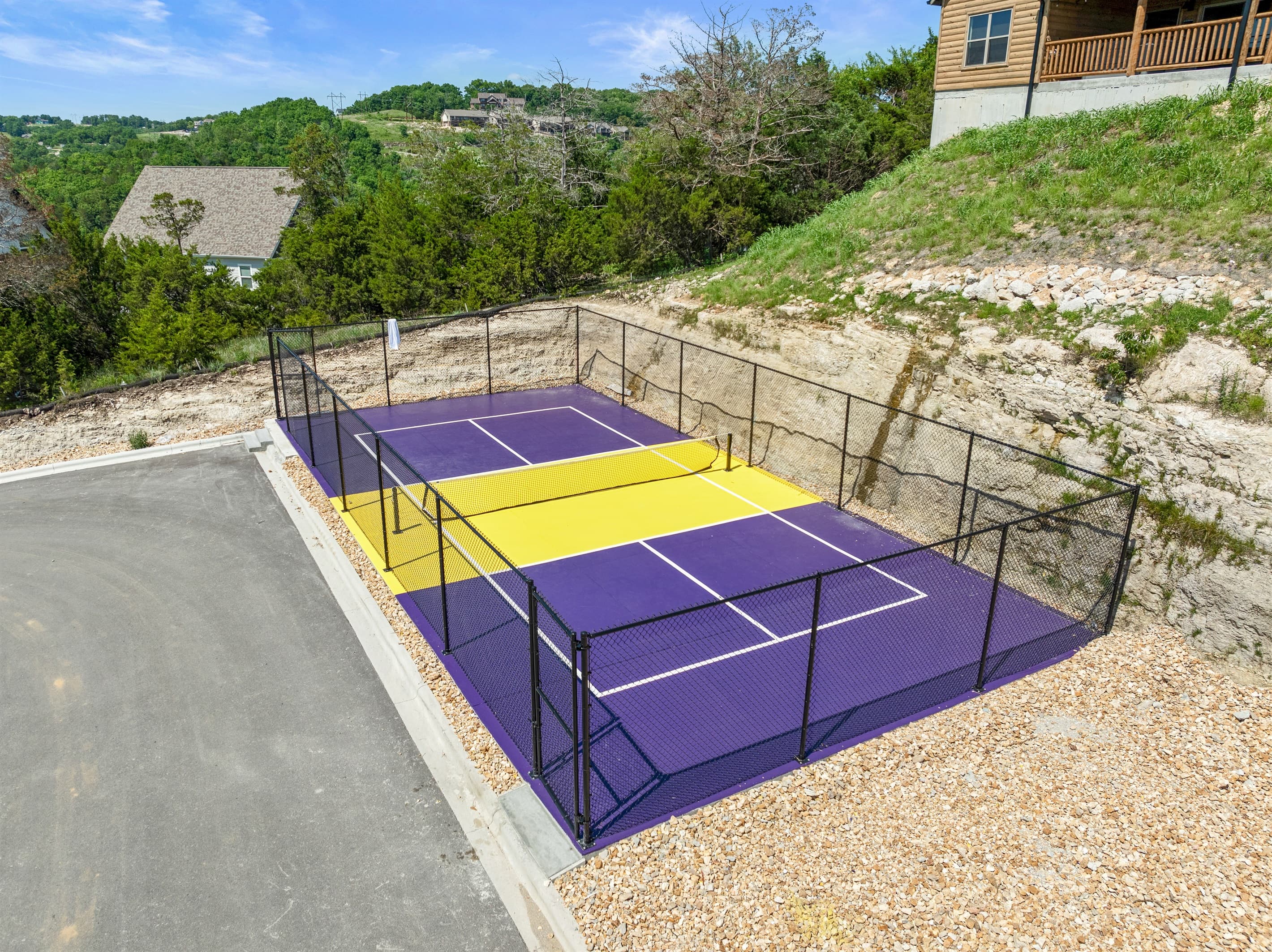 Fenced in tennis/pickleball court for guests to enjoy