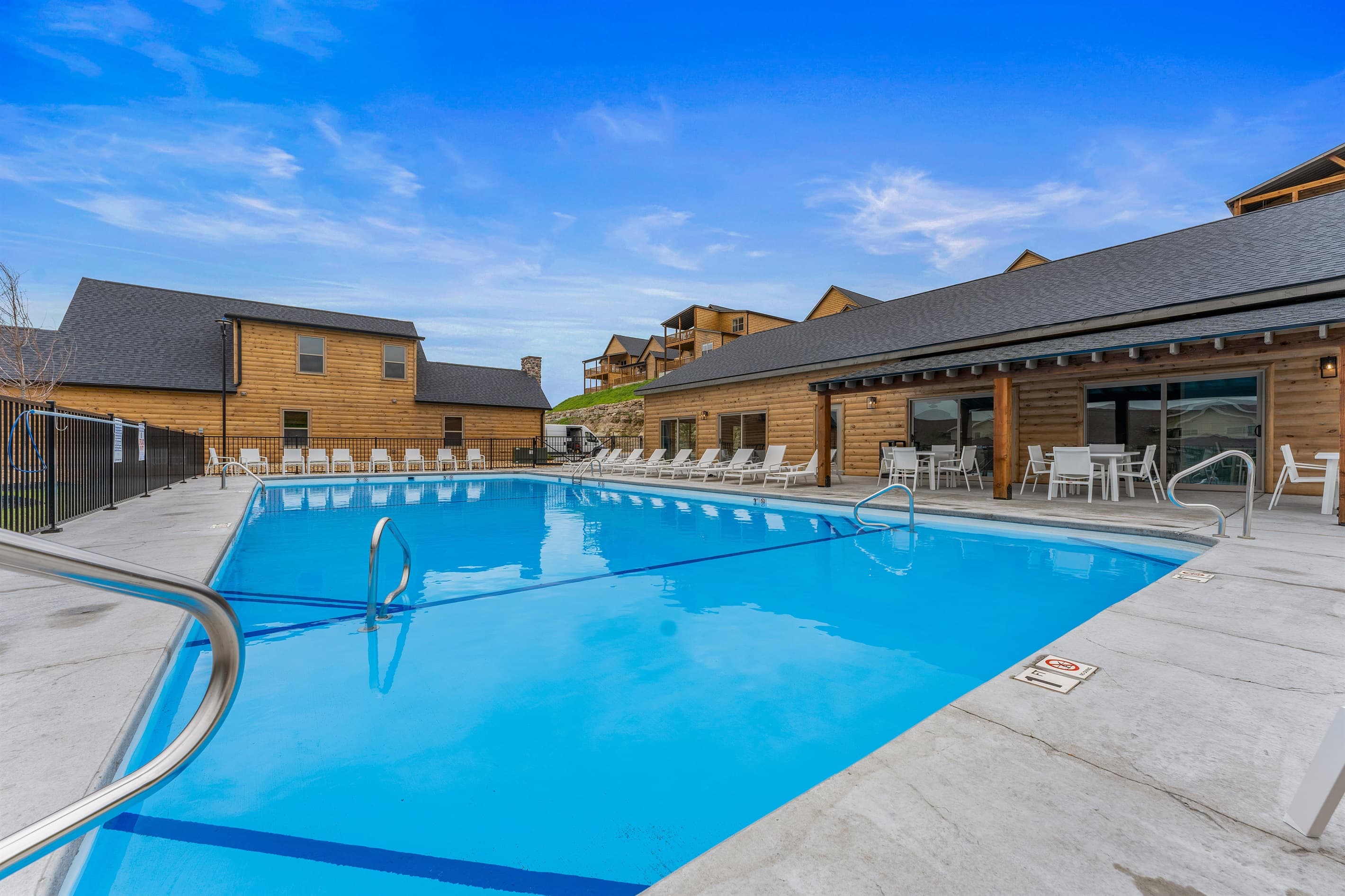 Outdoor pool for handle bars and steps to get in.