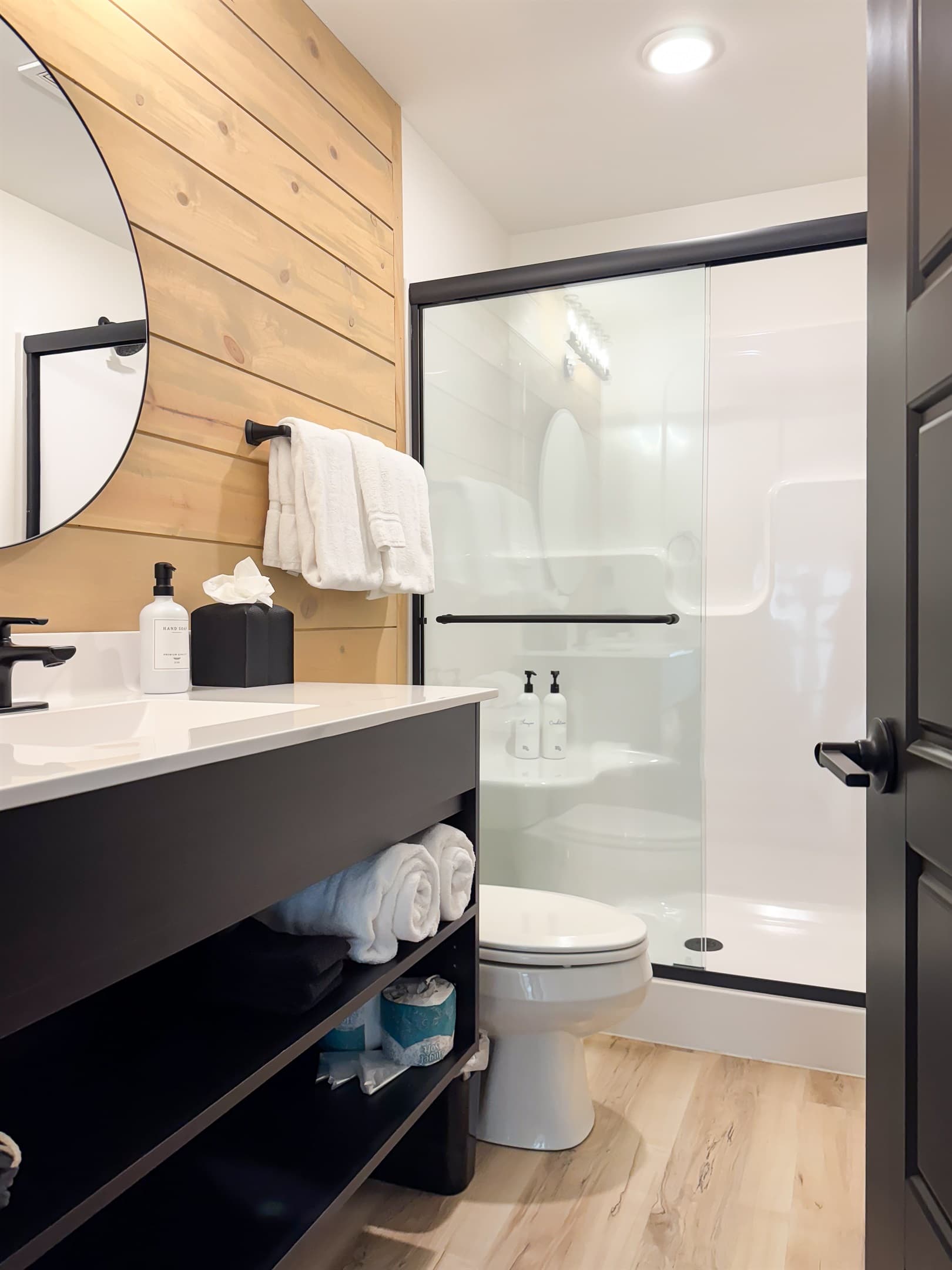 Bedroom 2: En-suite bathroom with low curb shower, toilet, and vanity