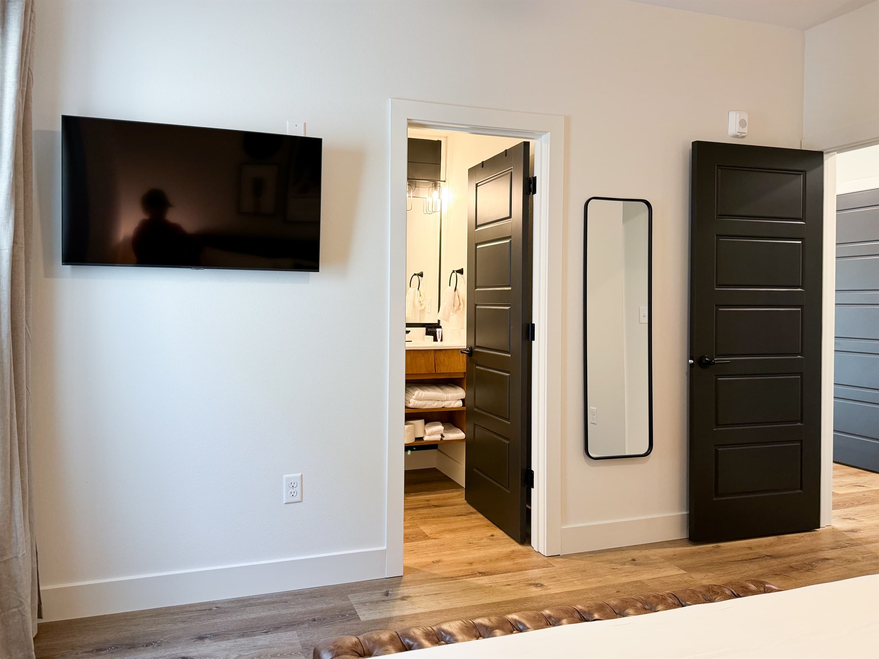 Bedroom 3: Tv, entrance to the en-suite bathroom, and fun length mirror