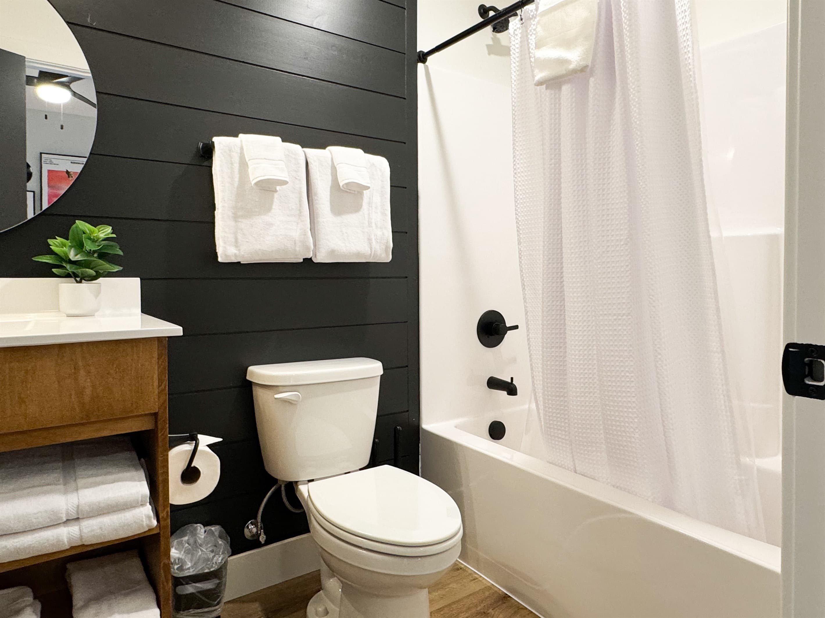 Bedroom 4: Ensuite bathroom with tub shower, toilet, and vanity
