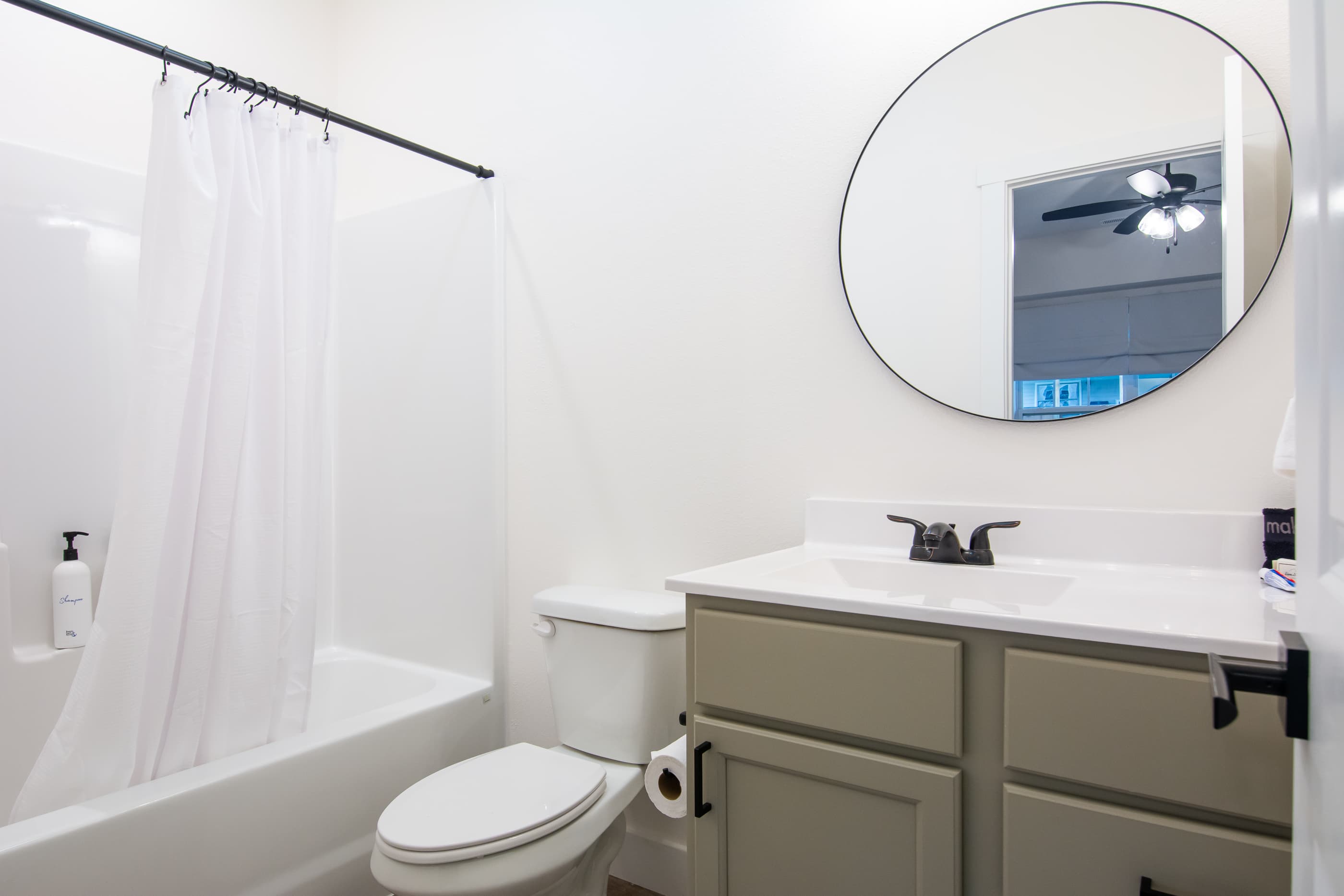 Bedroom 1 En-suite bathroom with tub shower, toilet, and vanity