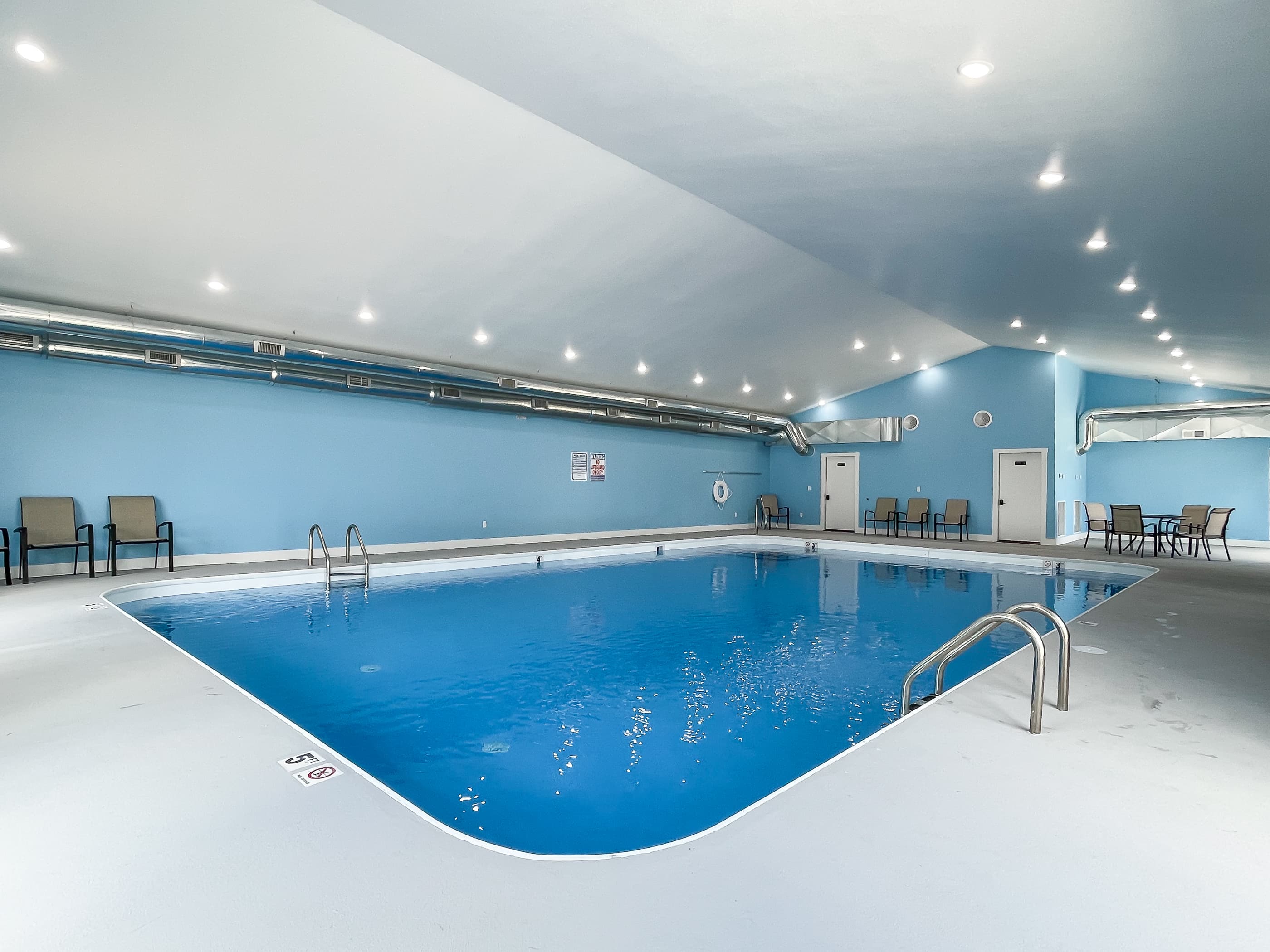 Indoor pool access with two ladders or steps down on the other end