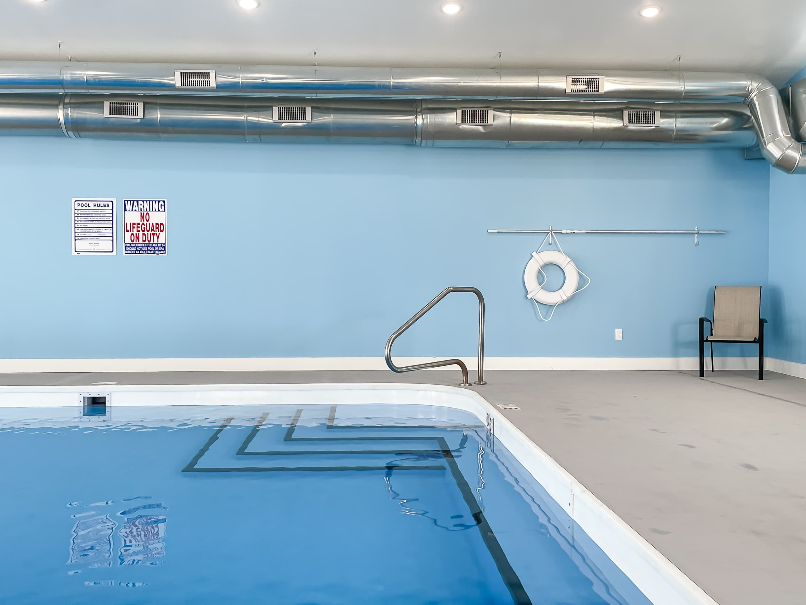 Indoor pool steps to get in with bar
