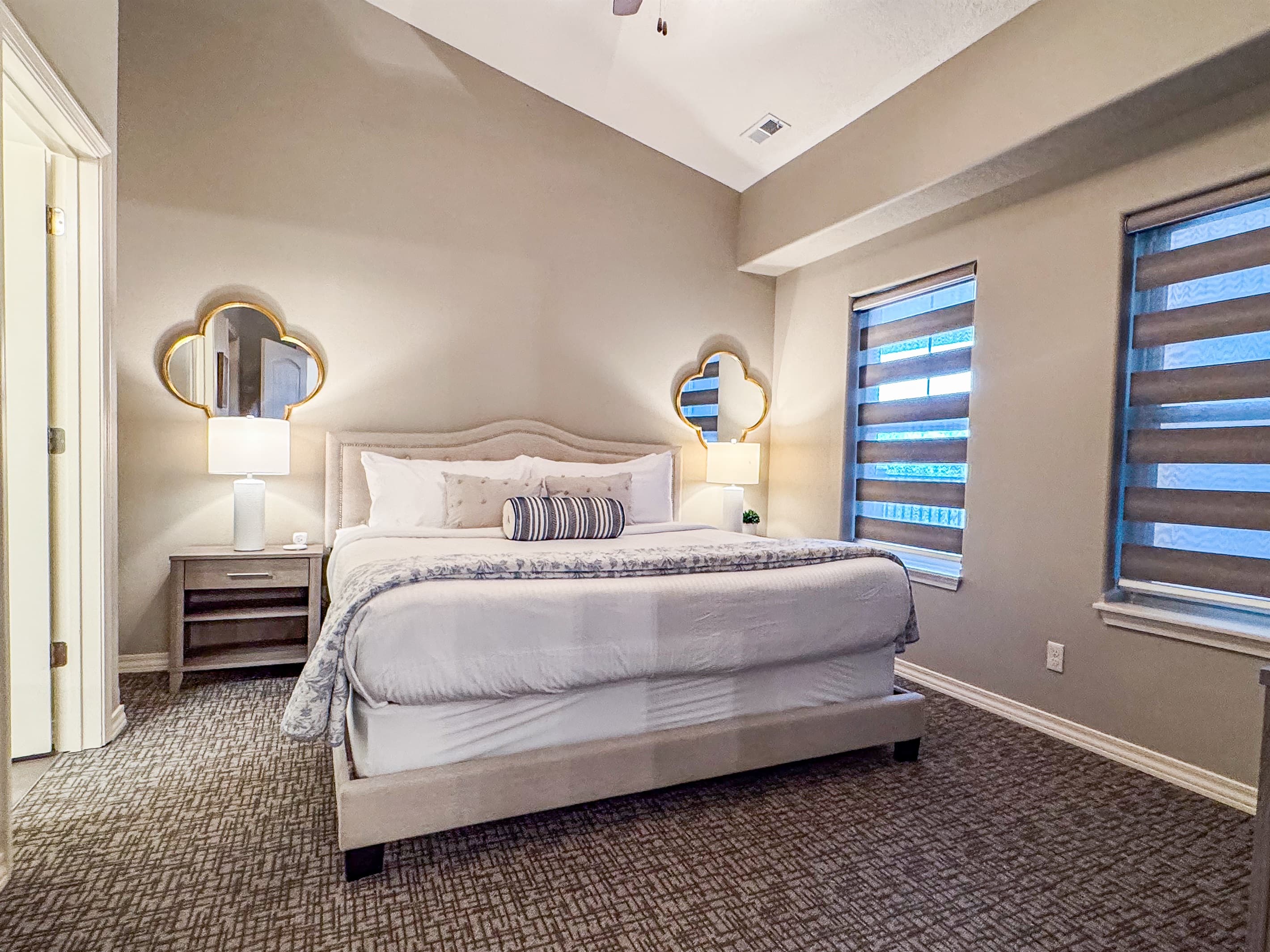 Main level bedroom 1 off the kitchen with king bed and en-suite bathroom