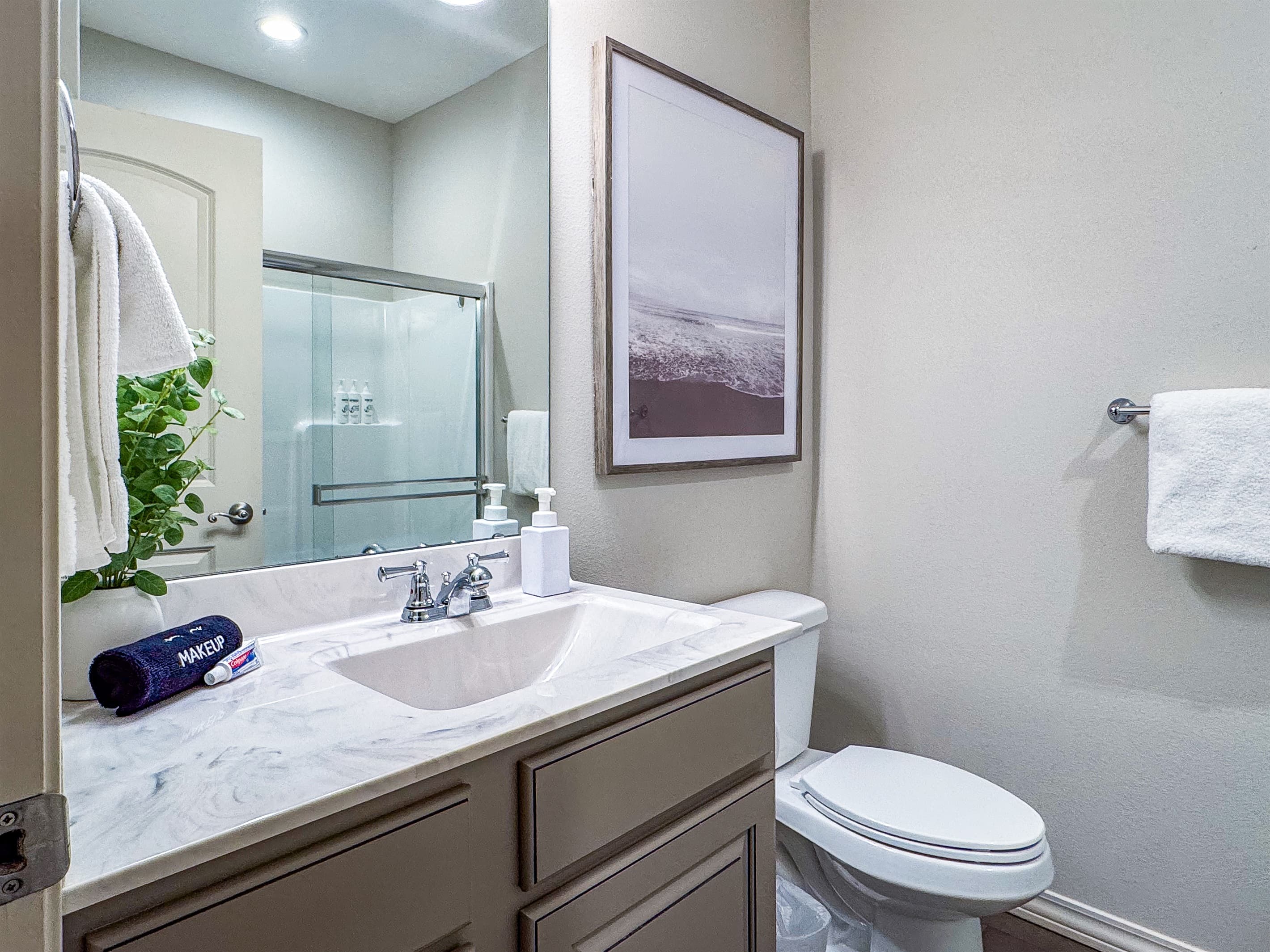 Bedroom 1 en-suite bathroom with spacious counter tops with sink and toilet 