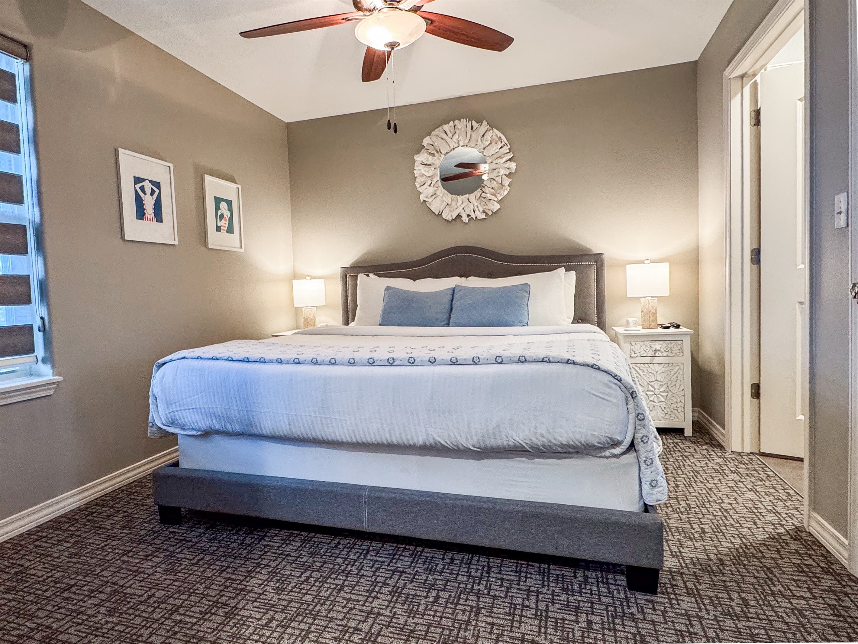 Main level bedroom 3 with king size bed with side tables and en-suite  bathroom