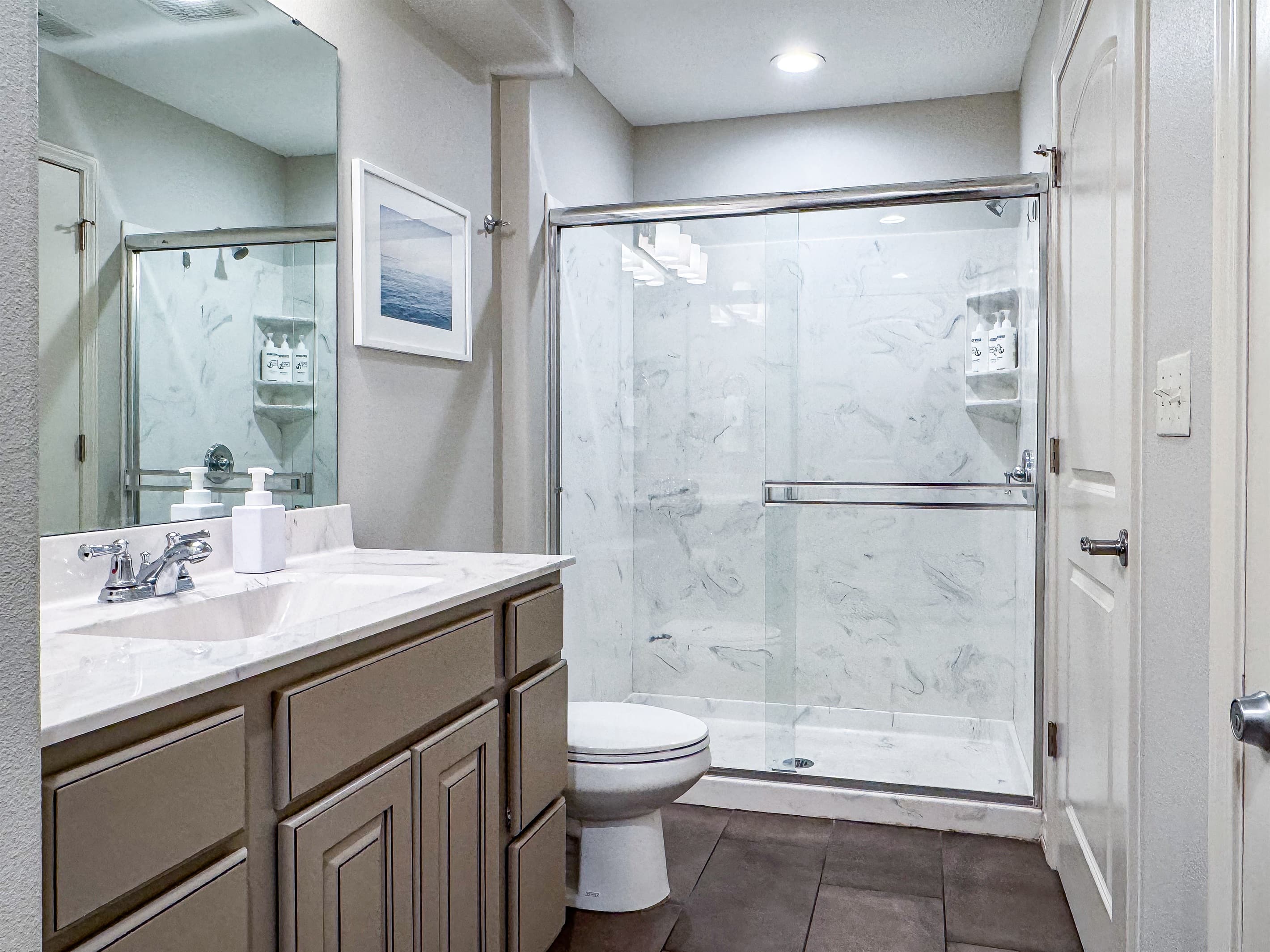 Bedroom 3 en-suite bathroom with spacious sink, toilet, and walk in shower 