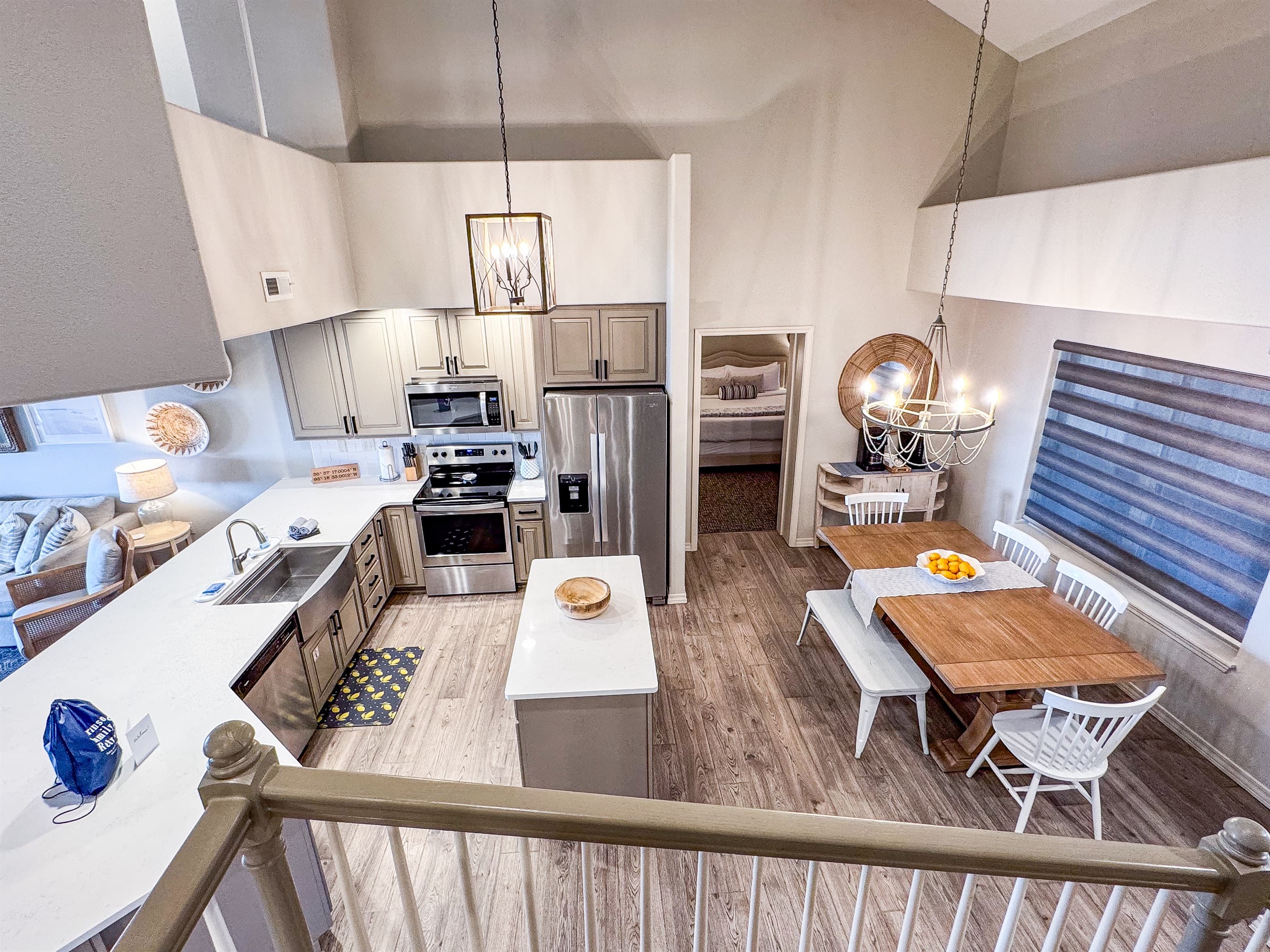 Stair view of lower level that showcases kitchen and bedroom off the kitchen