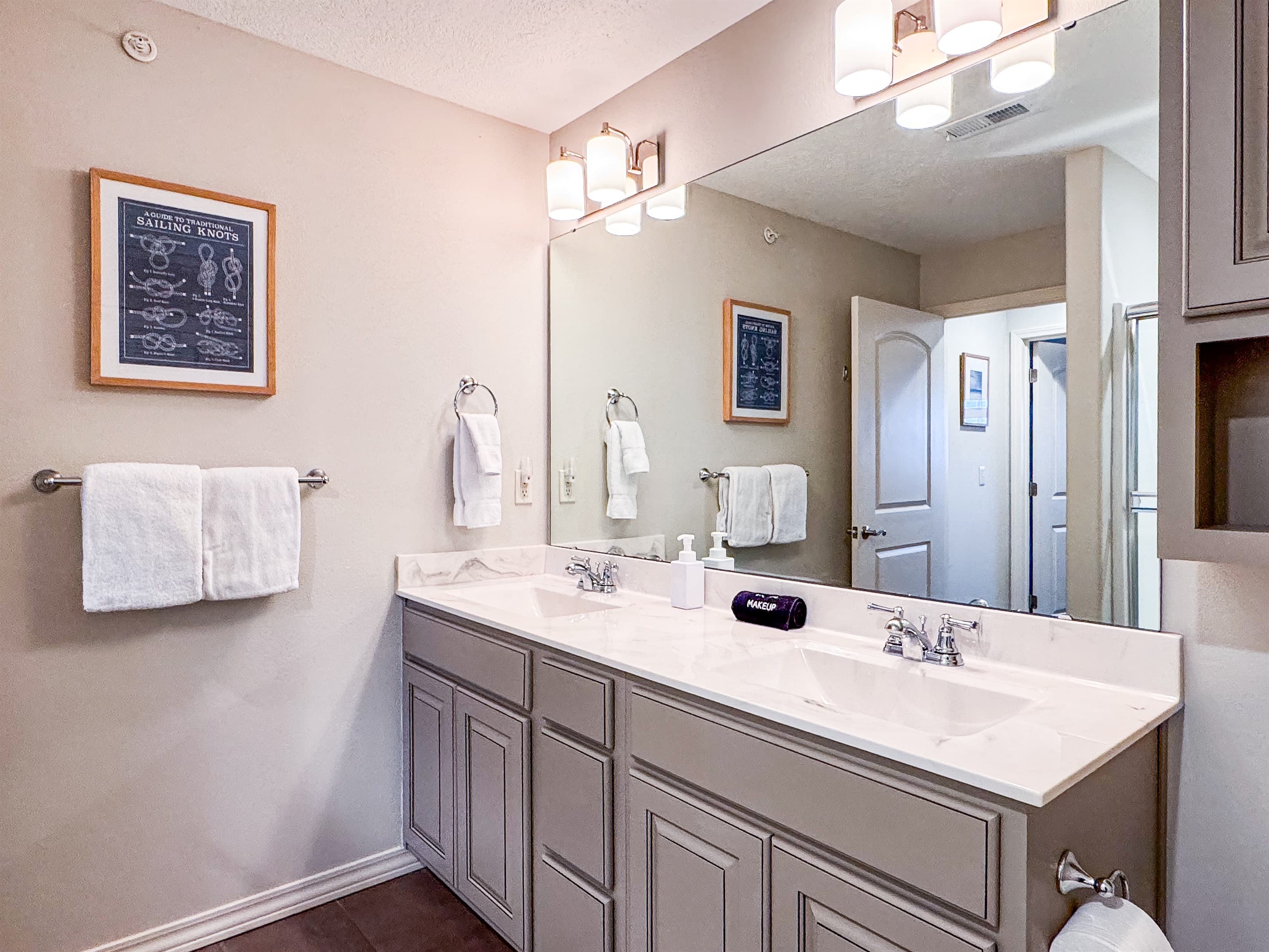 Upper level bathroom with a tub/shower combo and double vanity sinks