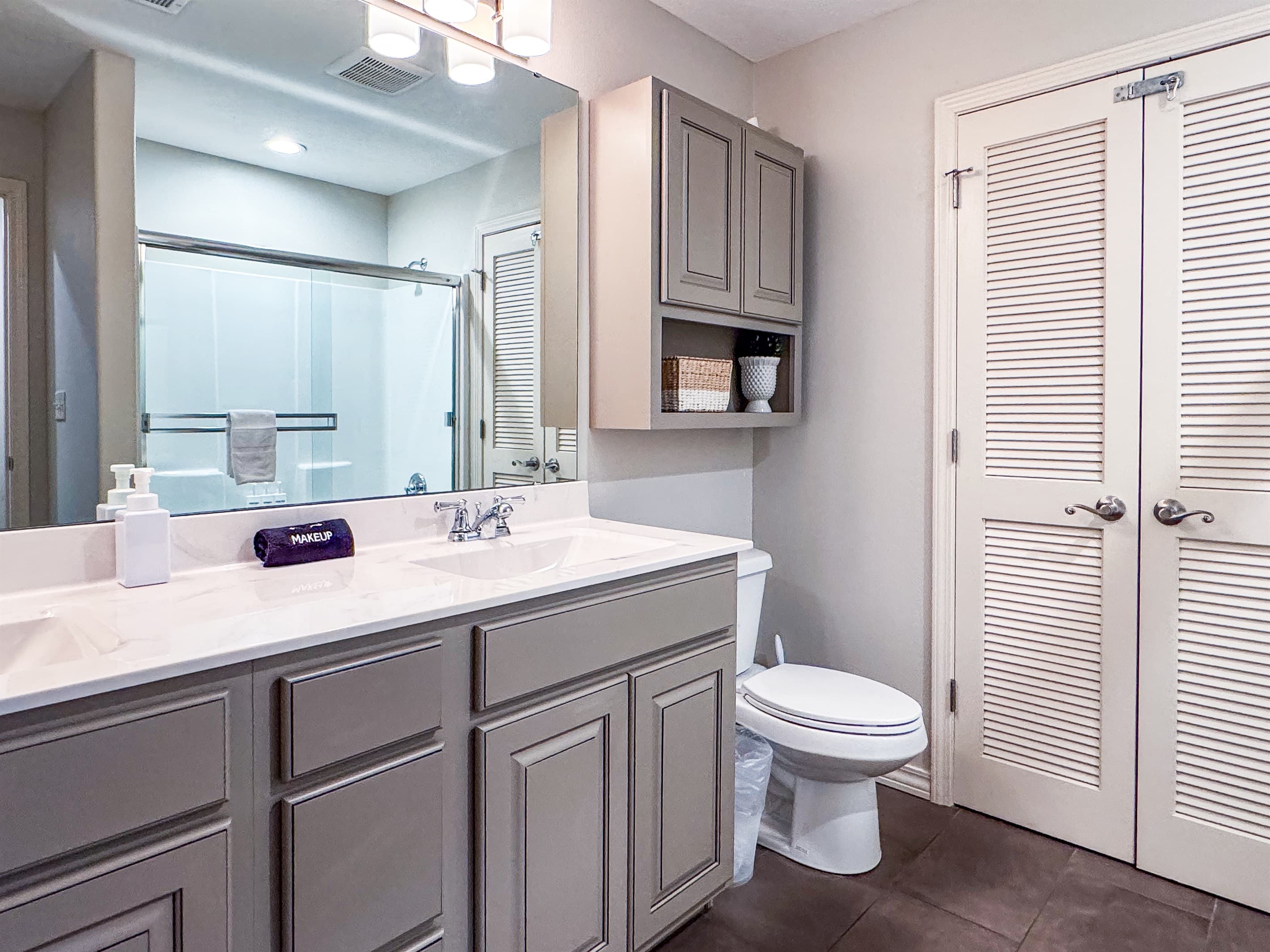 Upper level bathroom with a tub/shower combo and double vanity sinks