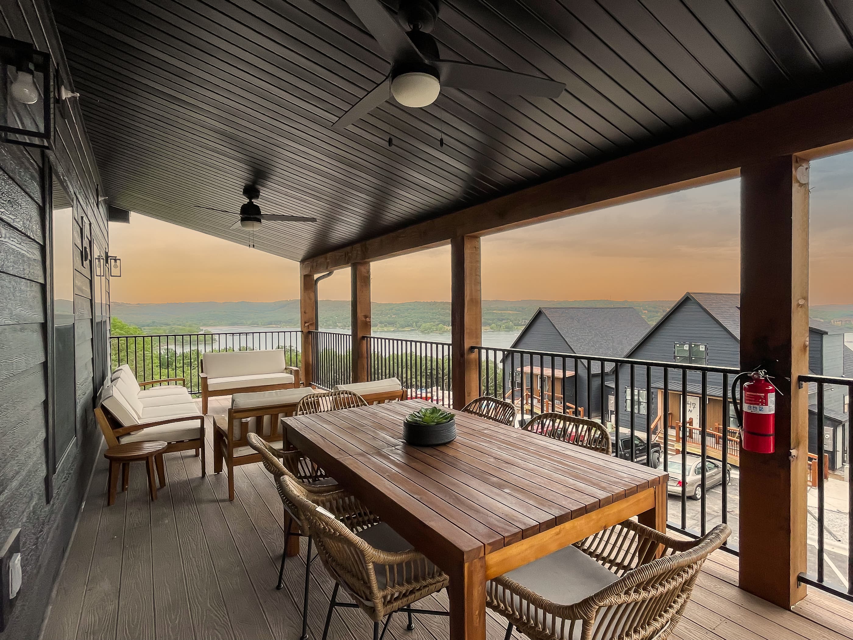 Cozy outdoor dining and seating area on main level deck overlooking Table Rock Lake