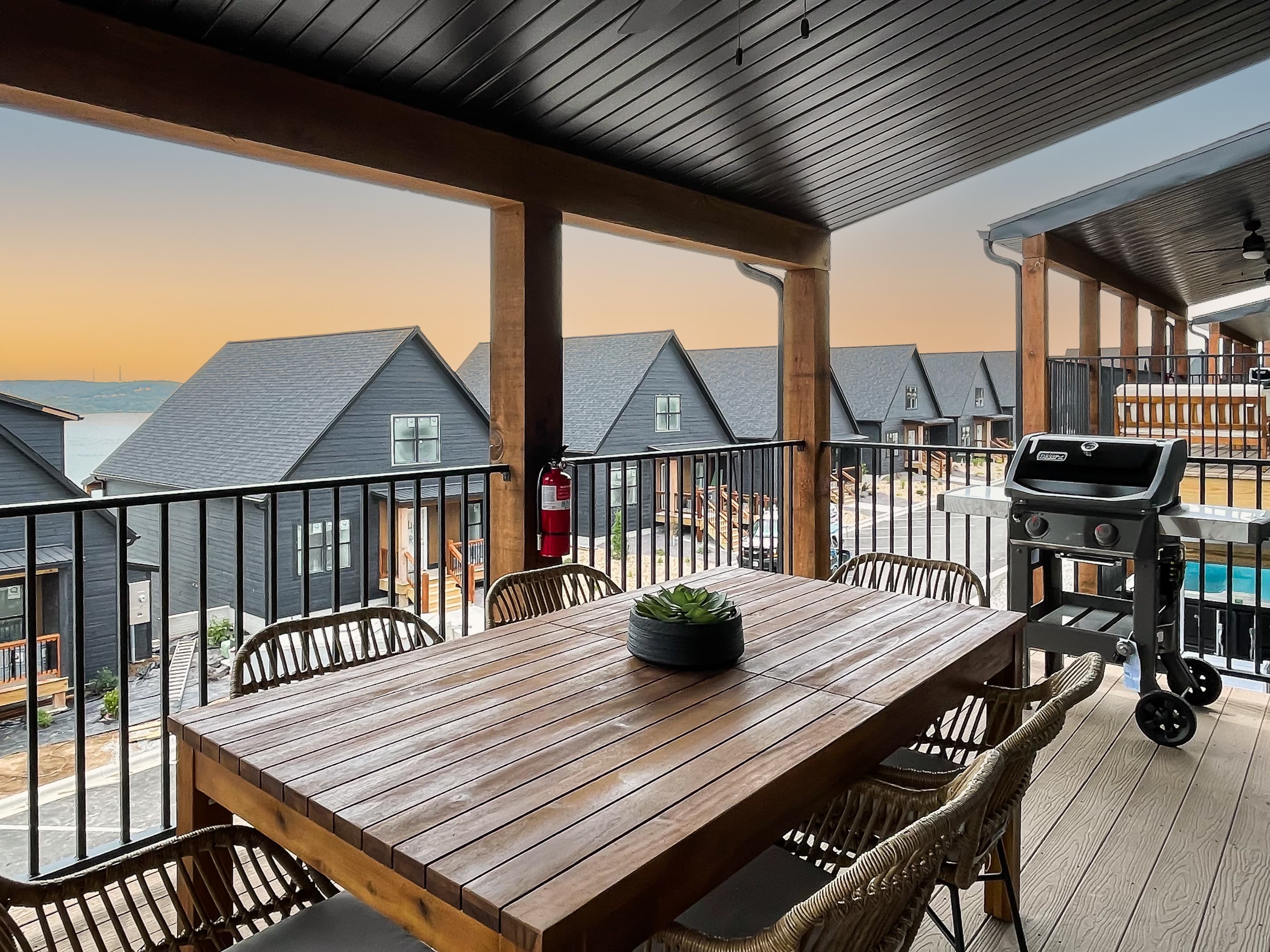 Cozy outdoor dining and seating area on main level deck overlooking Table Rock Lake