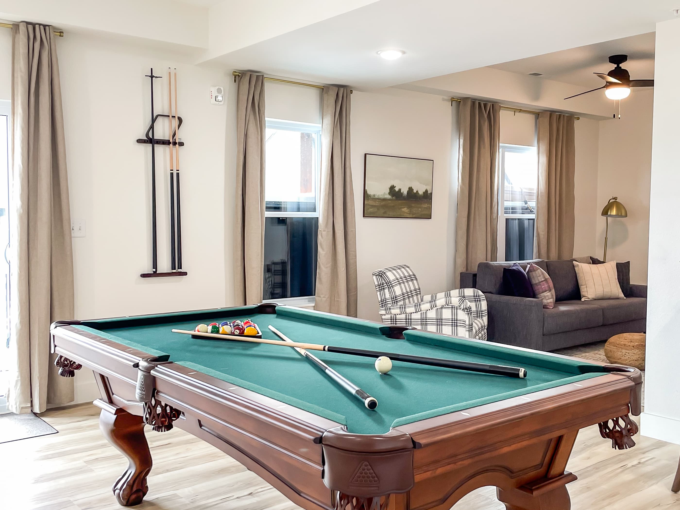 Unique and stylish lower level family room with pool table, football, and queen sofa sleeper