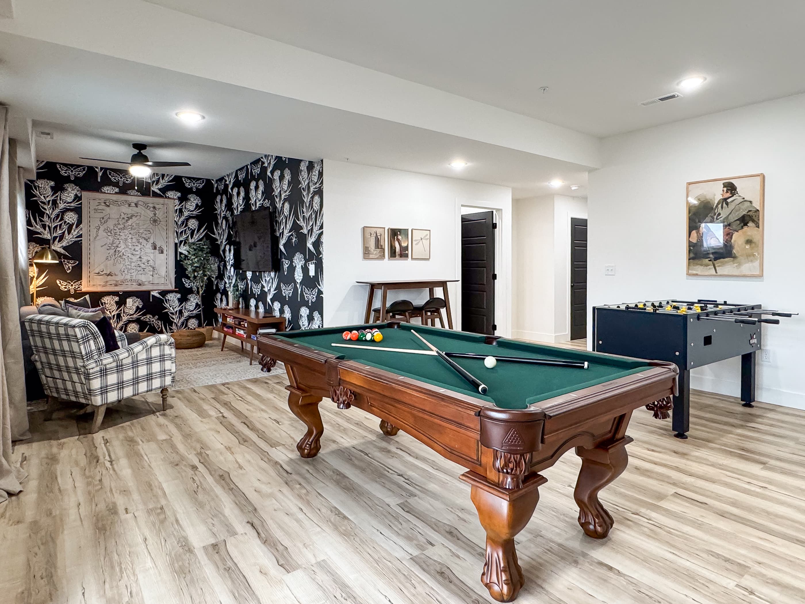 Unique and stylish lower level family room with pool table, football, and queen sofa sleeper