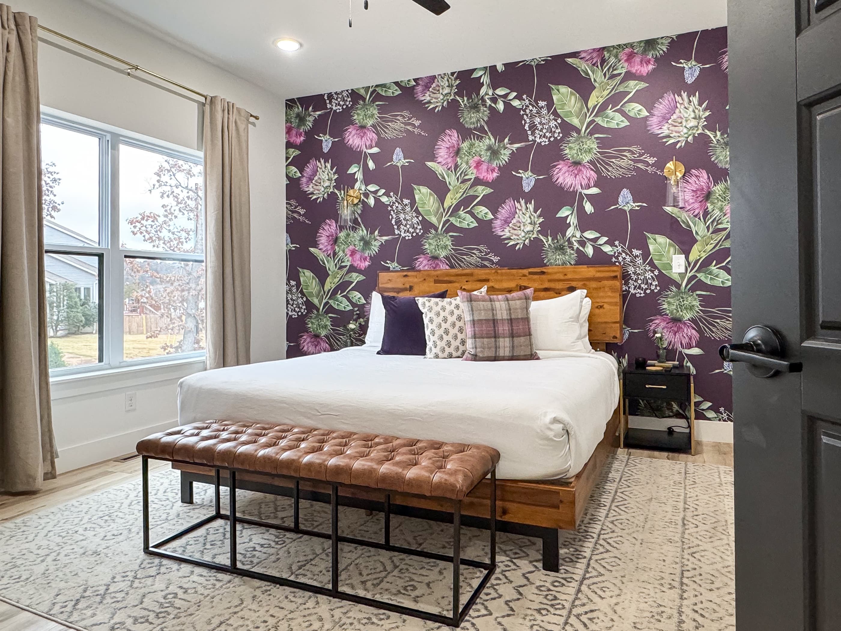 Main level king bedroom with inviting style and ample space around bed