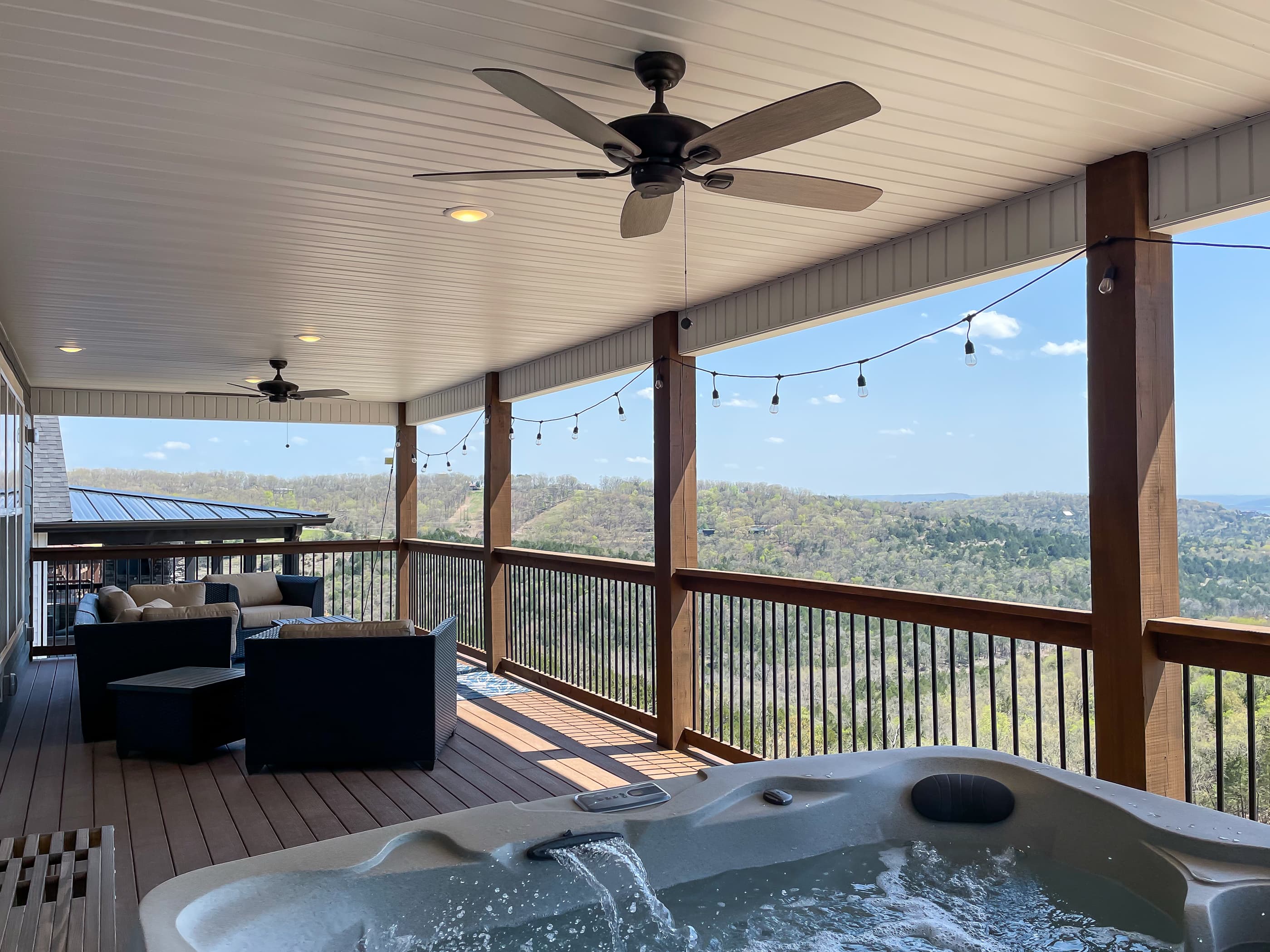 Upper deck with hot tub and a view