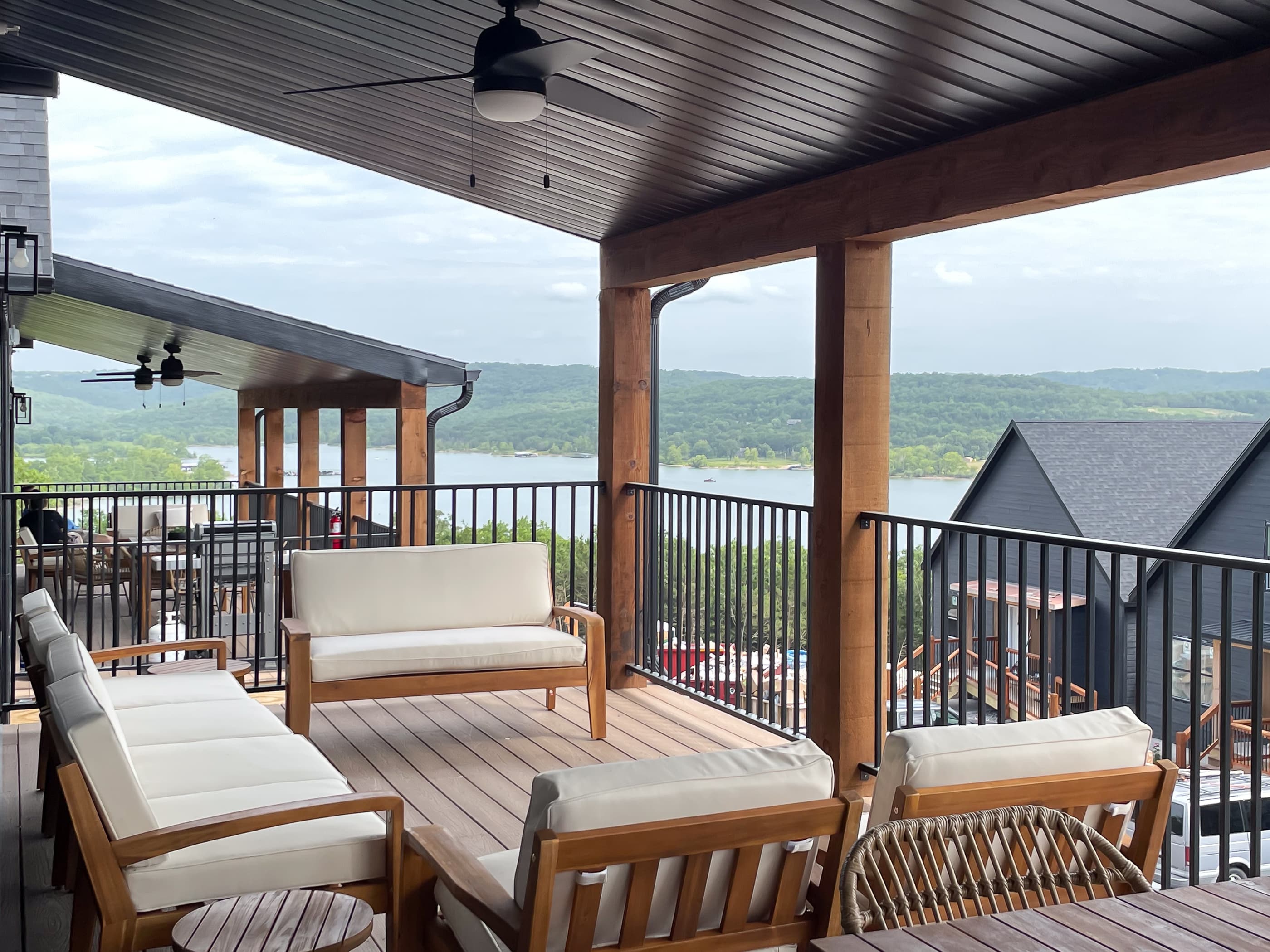 Deck with main level access, cozy seating, and stunning lake views
