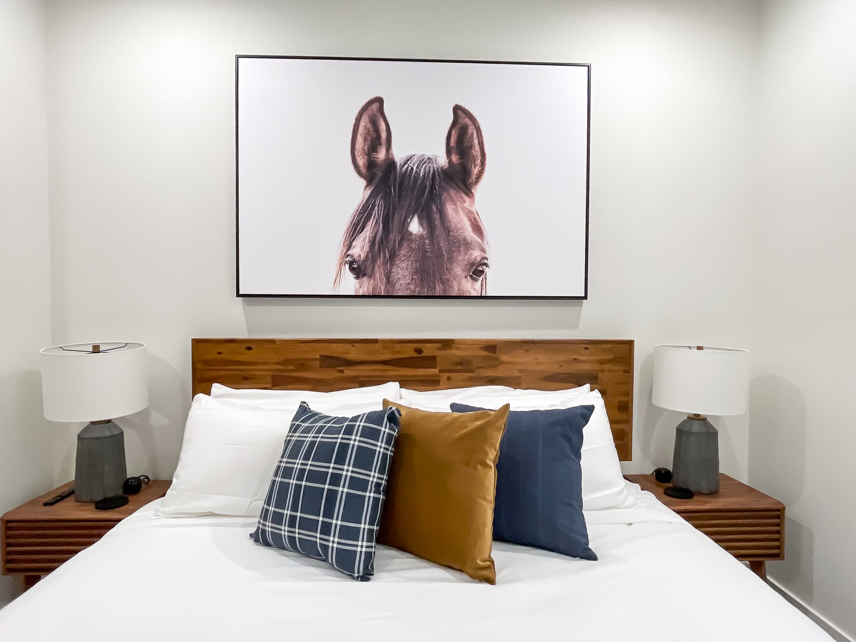 Lower level middle bedroom with nightstands, tv, and en suite bathroom