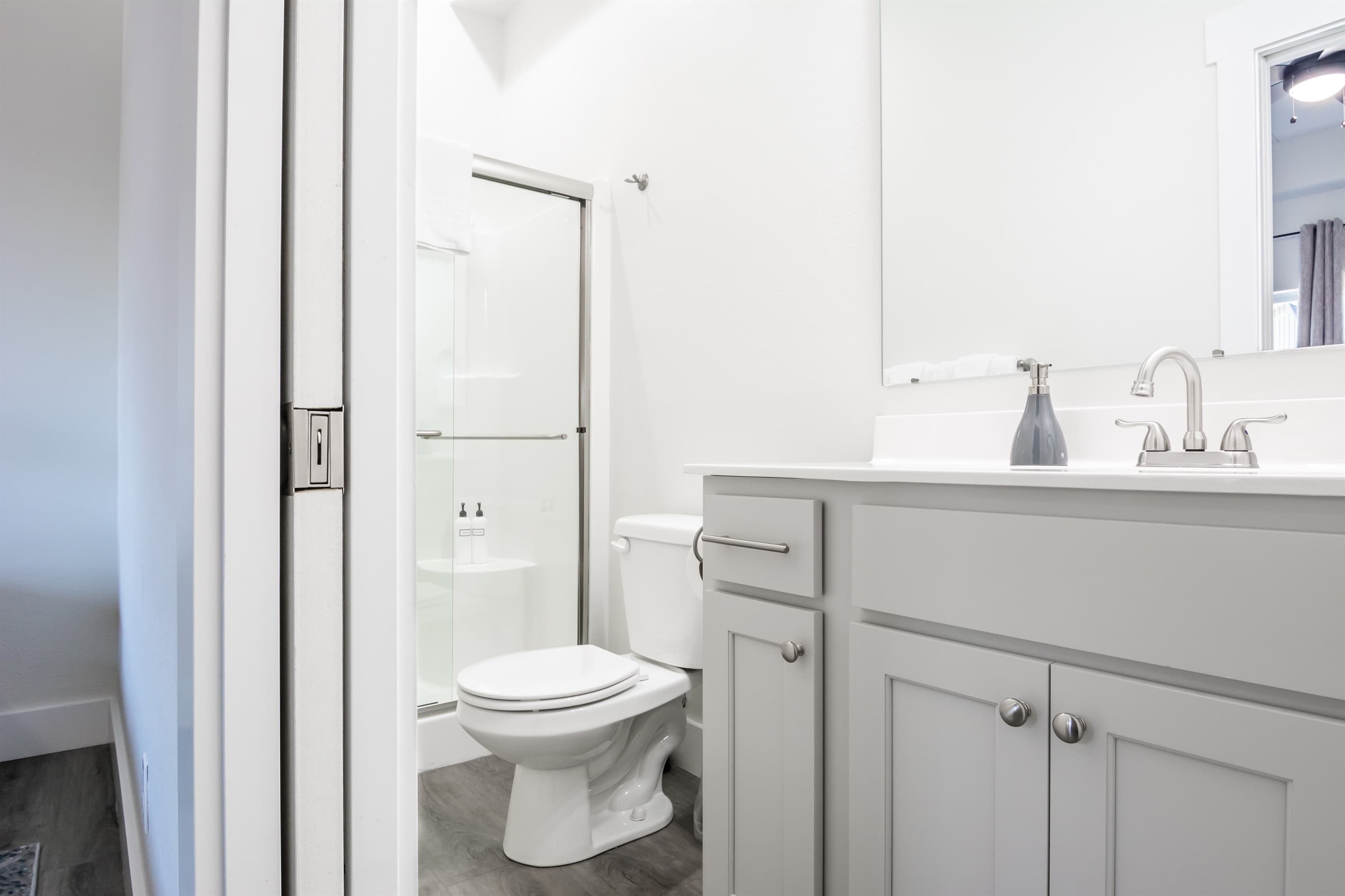 Bathroom 6 en-suite low curb shower, toilet, and vanity