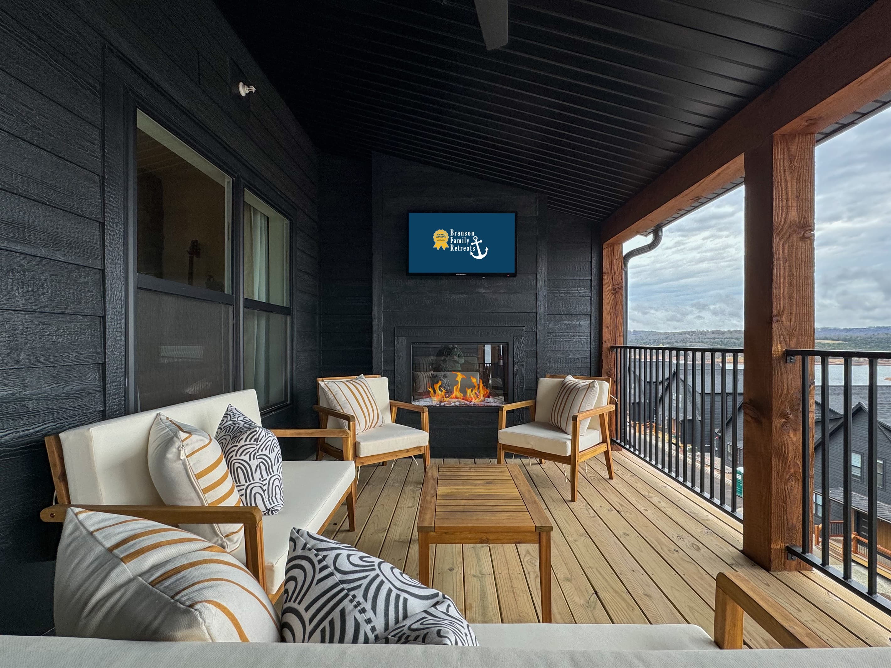 Seating area on deck with electric fire place with Tv above