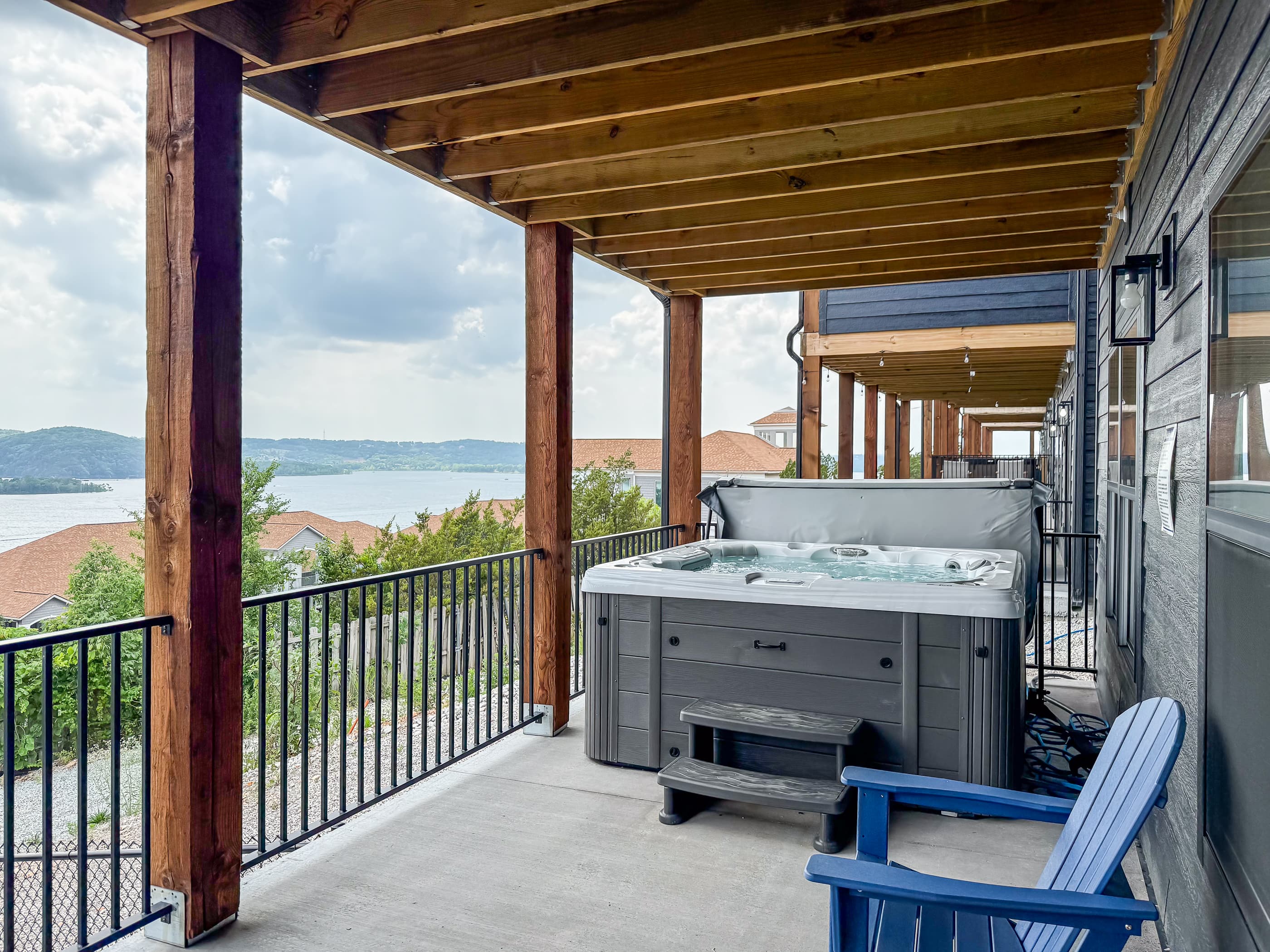 Hot tub has steps to get in and a cover