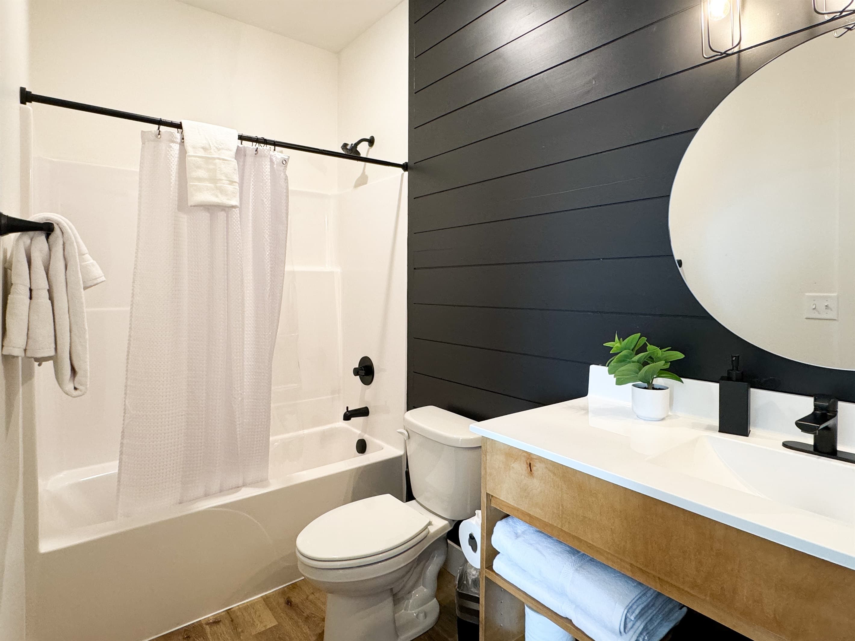 Bedroom 7: (4) Queen beds en-suite bathroom with tub shower, toilet, and vanity