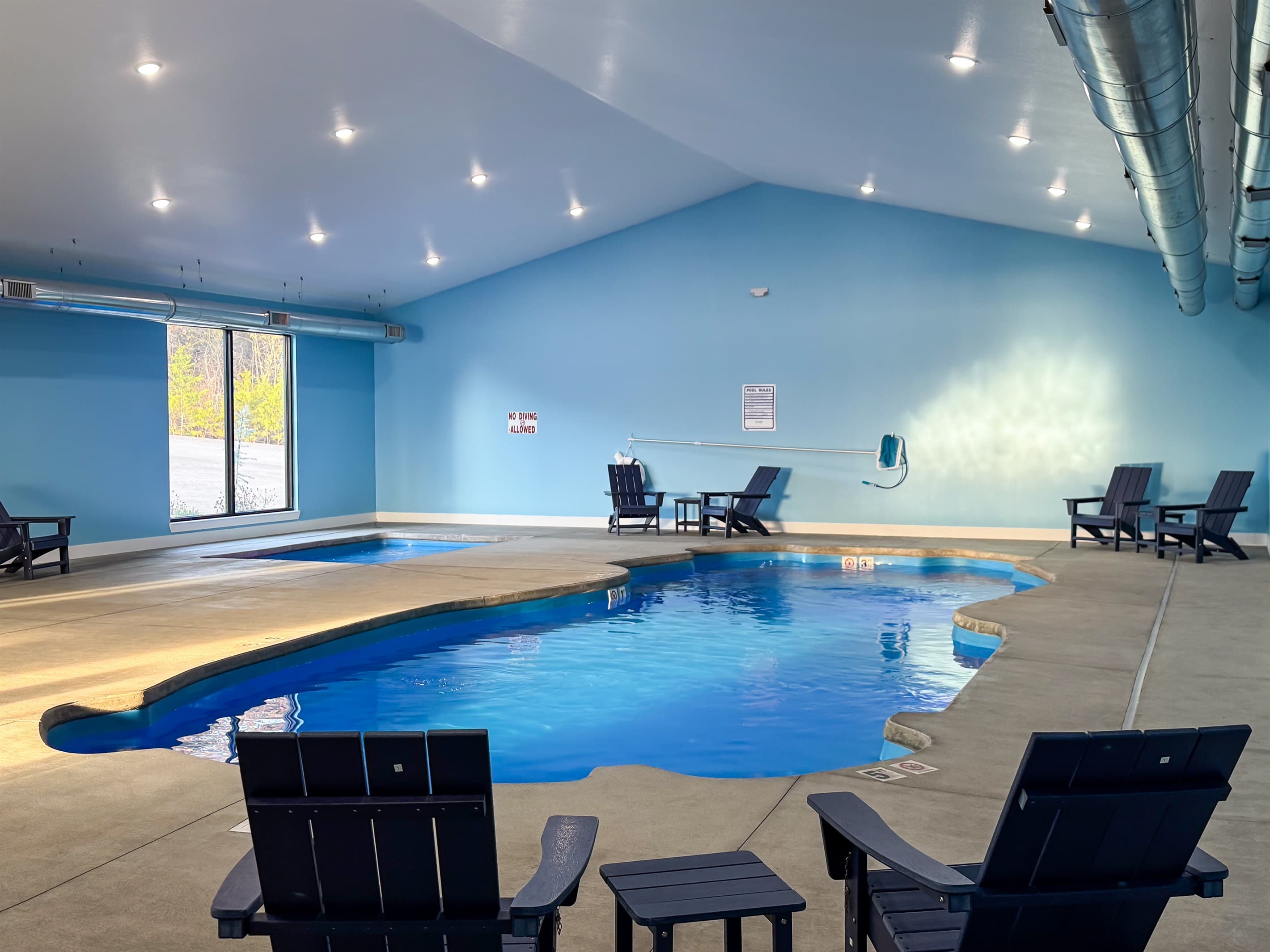 Indoor pool area with seating