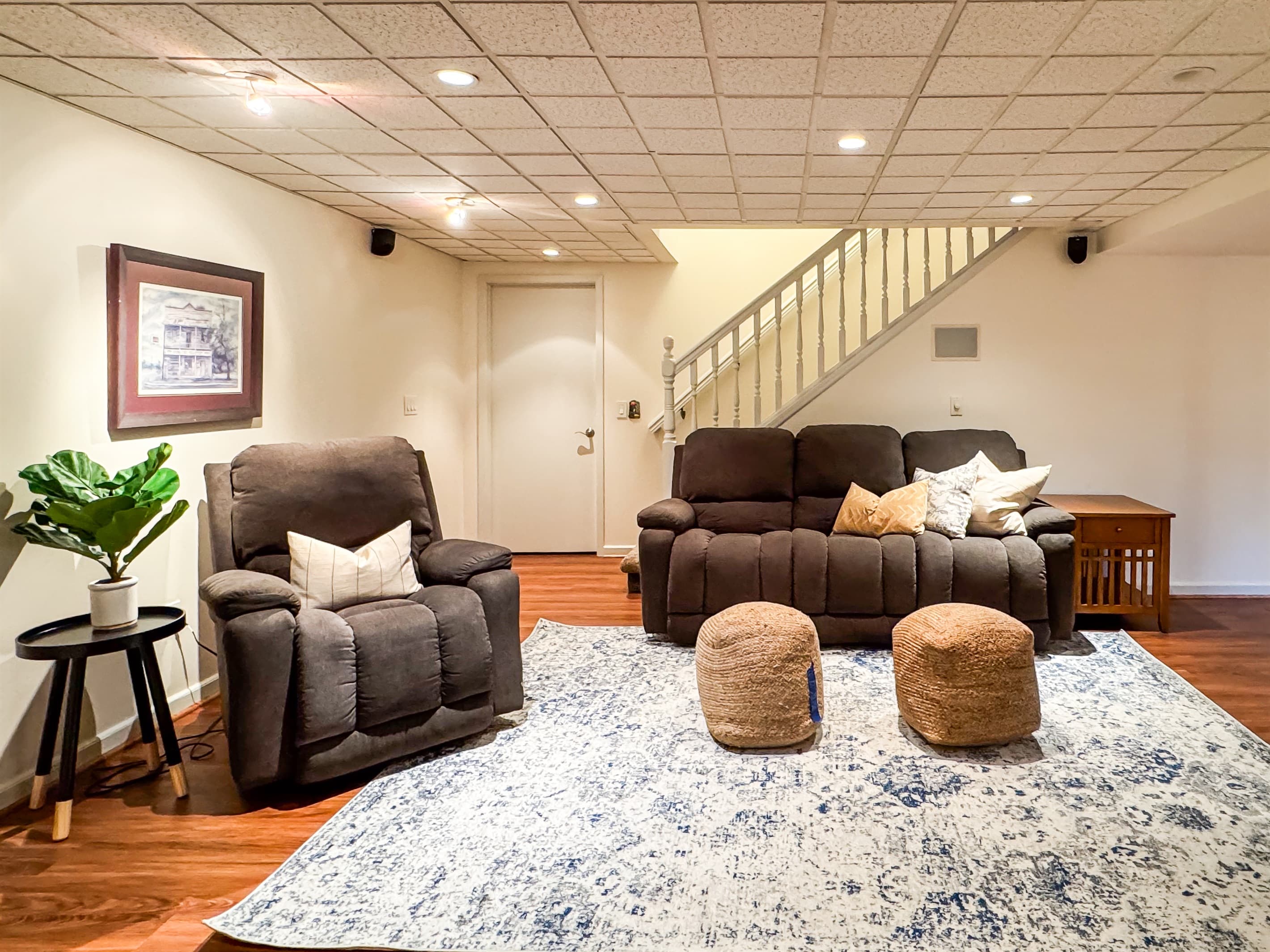 Spacious lower level entertainment area with plenty of room to spread out with comfortable reclining couch and chair ready for movie night at Pointer Haus.